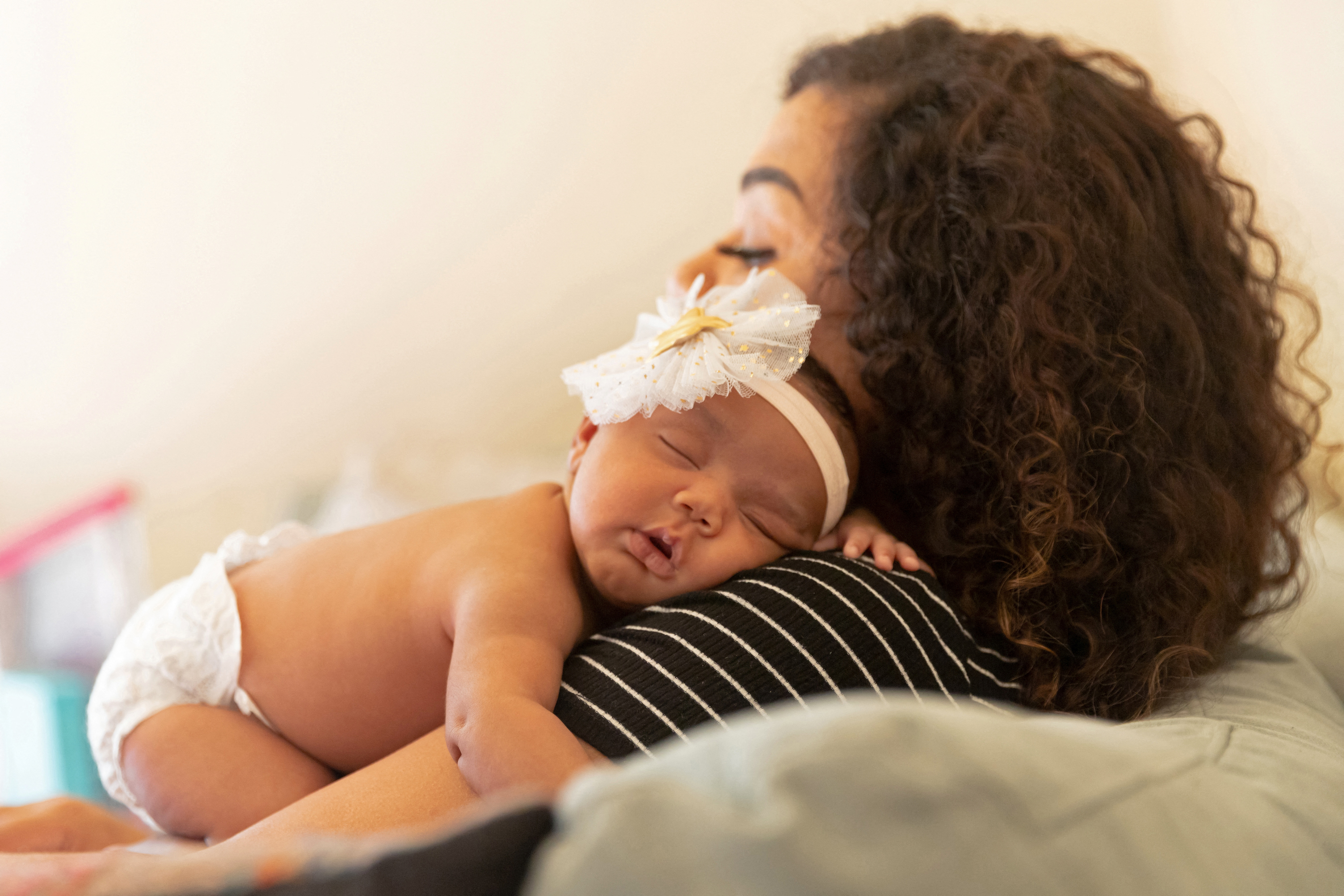 Bianca Haynes holds her sleeping newborn daughter Zuri in Elmwood Park, New Jersey, U.S., May 30, 2022. REUTERS/Joy Malone