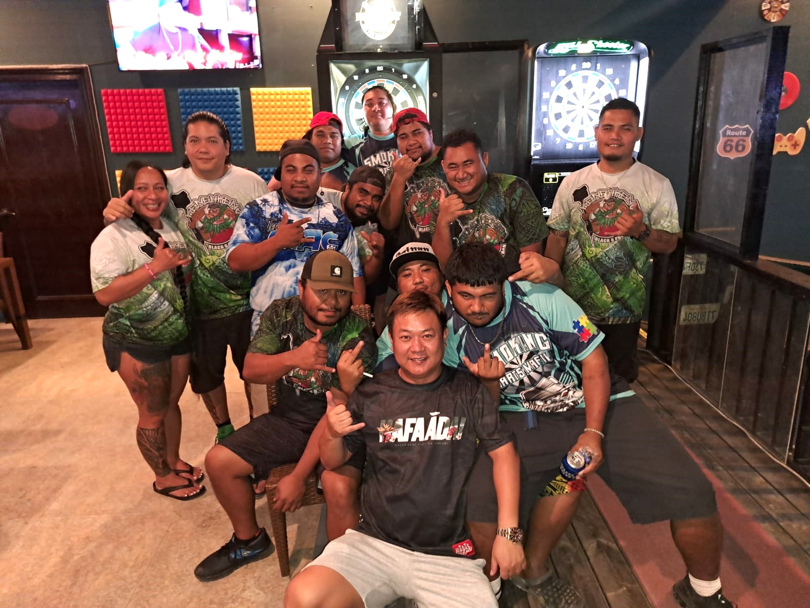 The Black 8 Smokin Dart Mafia and the Kenehkenz pose for a photo after their C Chichirika Division match in the 2023 SEDA Bud Light Dart League at the Black 8 Bar.