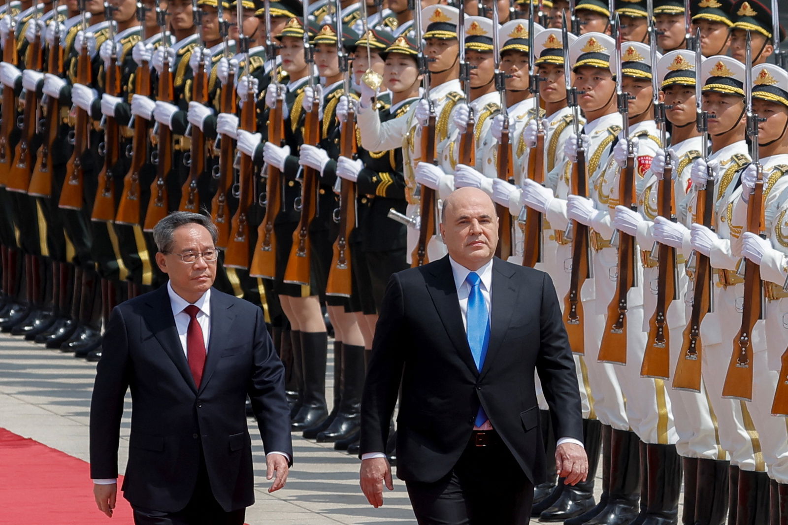 Russian Prime Minister Mikhail Mishustin and Chinese Premier Li Qiang attend a welcoming ceremony in Beijing, China, May 24, 2023. REUTERS/Thomas Peter/Pool