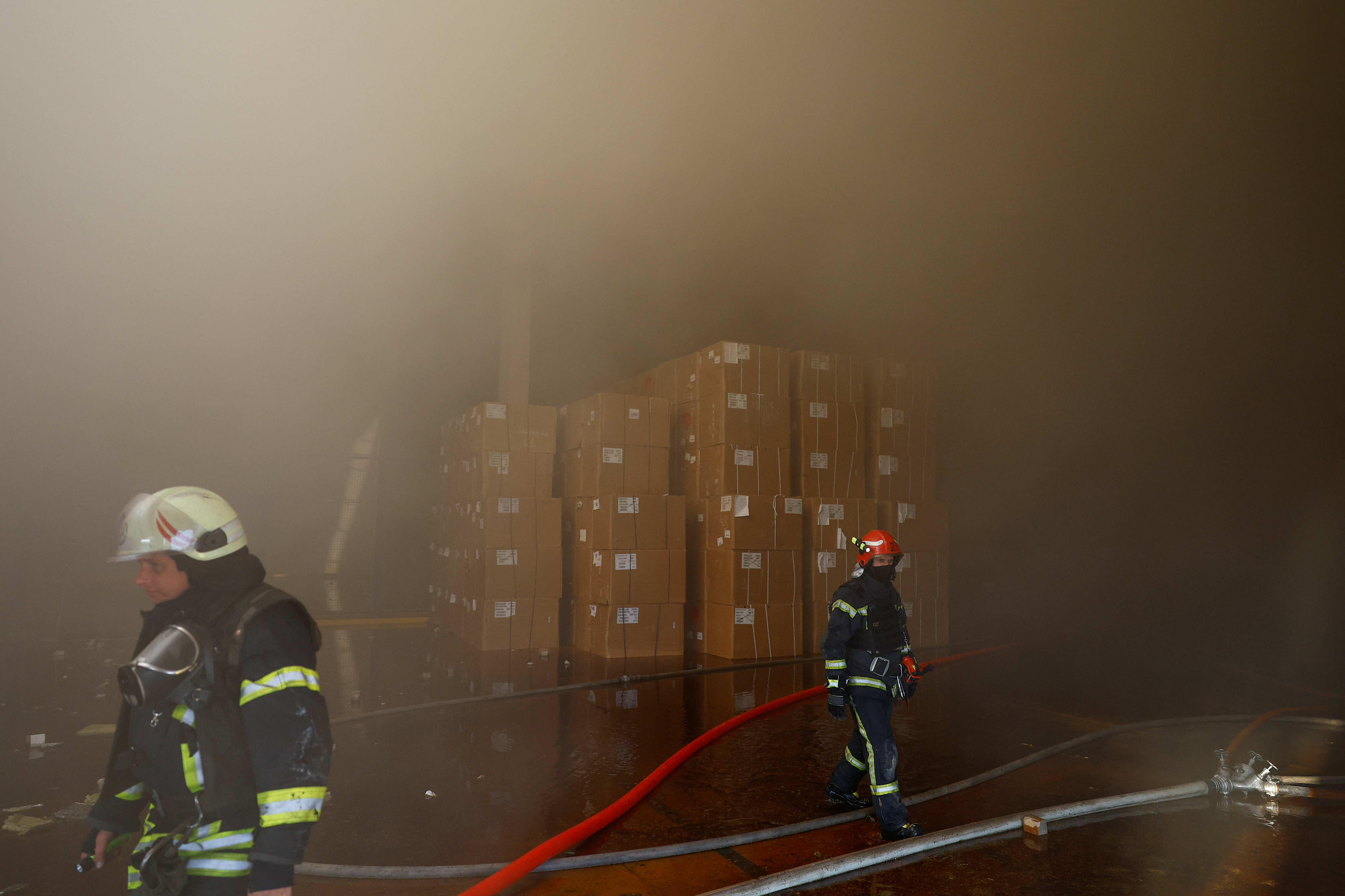 Firefighters work at a site of a tobacco factory damaged during Russian suicide drone strike, amid Russia's attack on Ukraine, in Kyiv, Ukraine May 28, 2023. REUTERS/Valentyn Ogirenko.