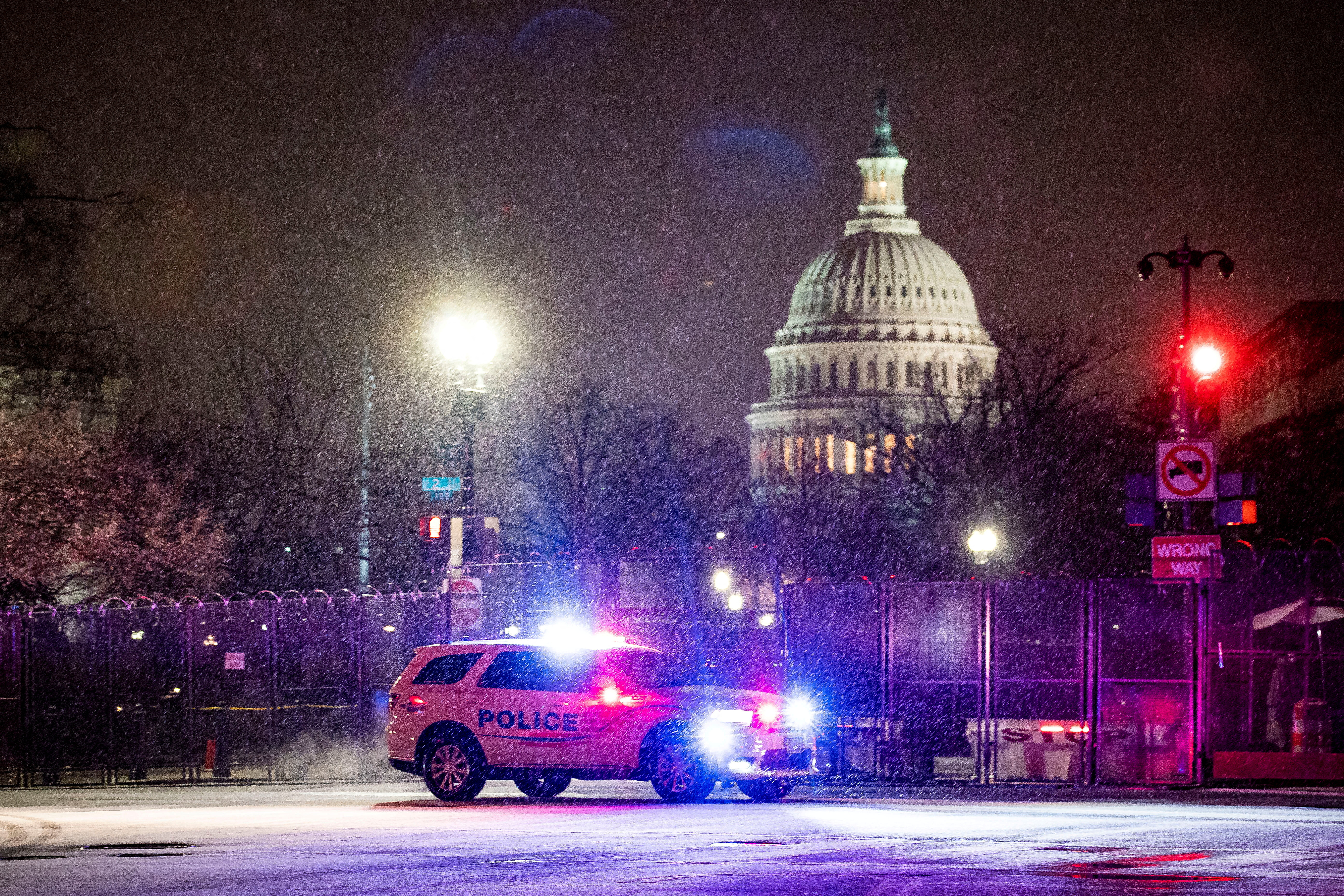 FILE PHOTO: A Metropolitan Police Department car drives through the snow on Capitol Hill in Washington, U.S., January 25, 2021. REUTERS/Al Drago