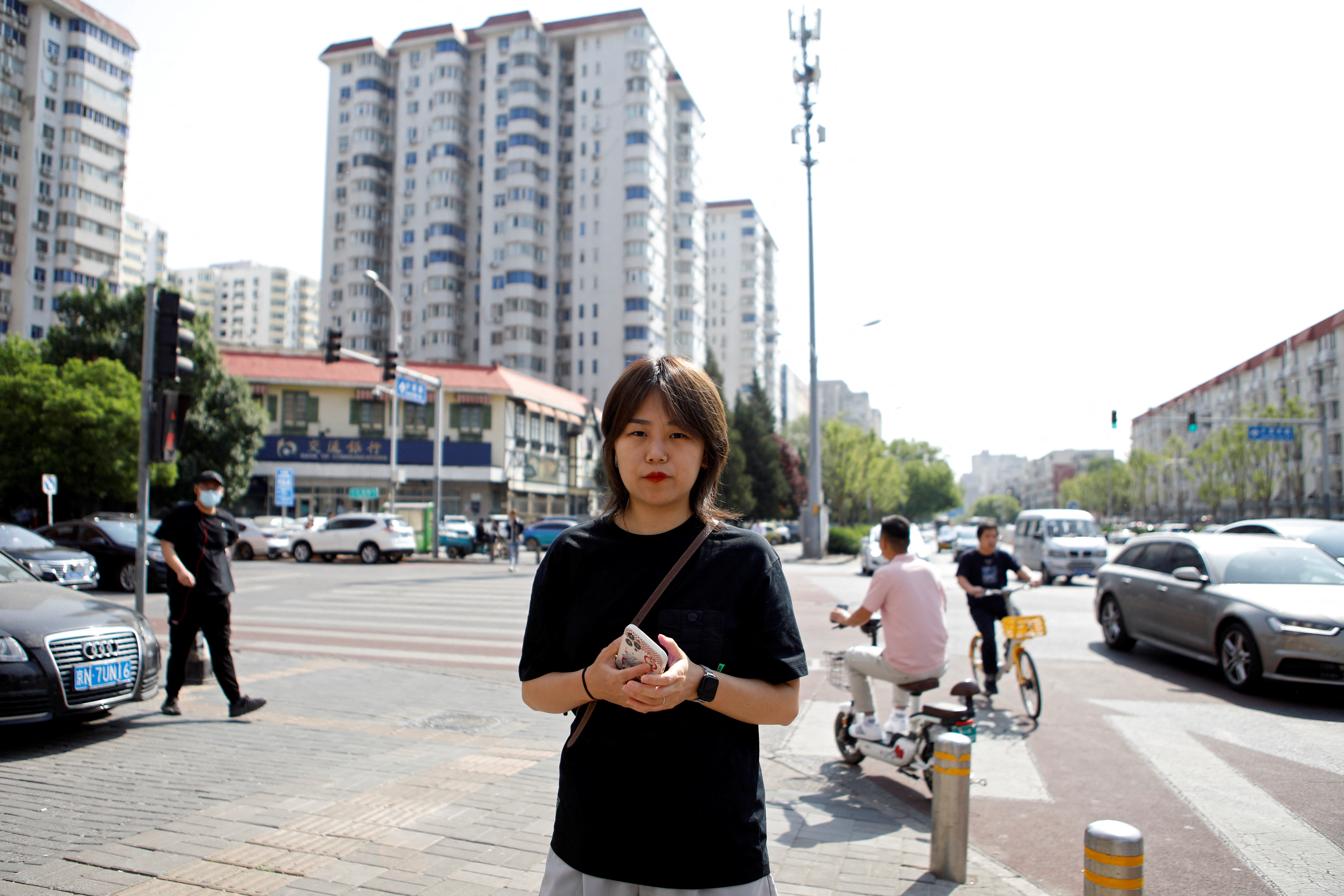 Teresa Xu, 35, holds her cellphone during an interview with Reuters about her lawsuit against a hospital for refusing to freeze her eggs because she is unmarried, in Beijing, China May 10, 2023. REUTERS/Florence Lo
