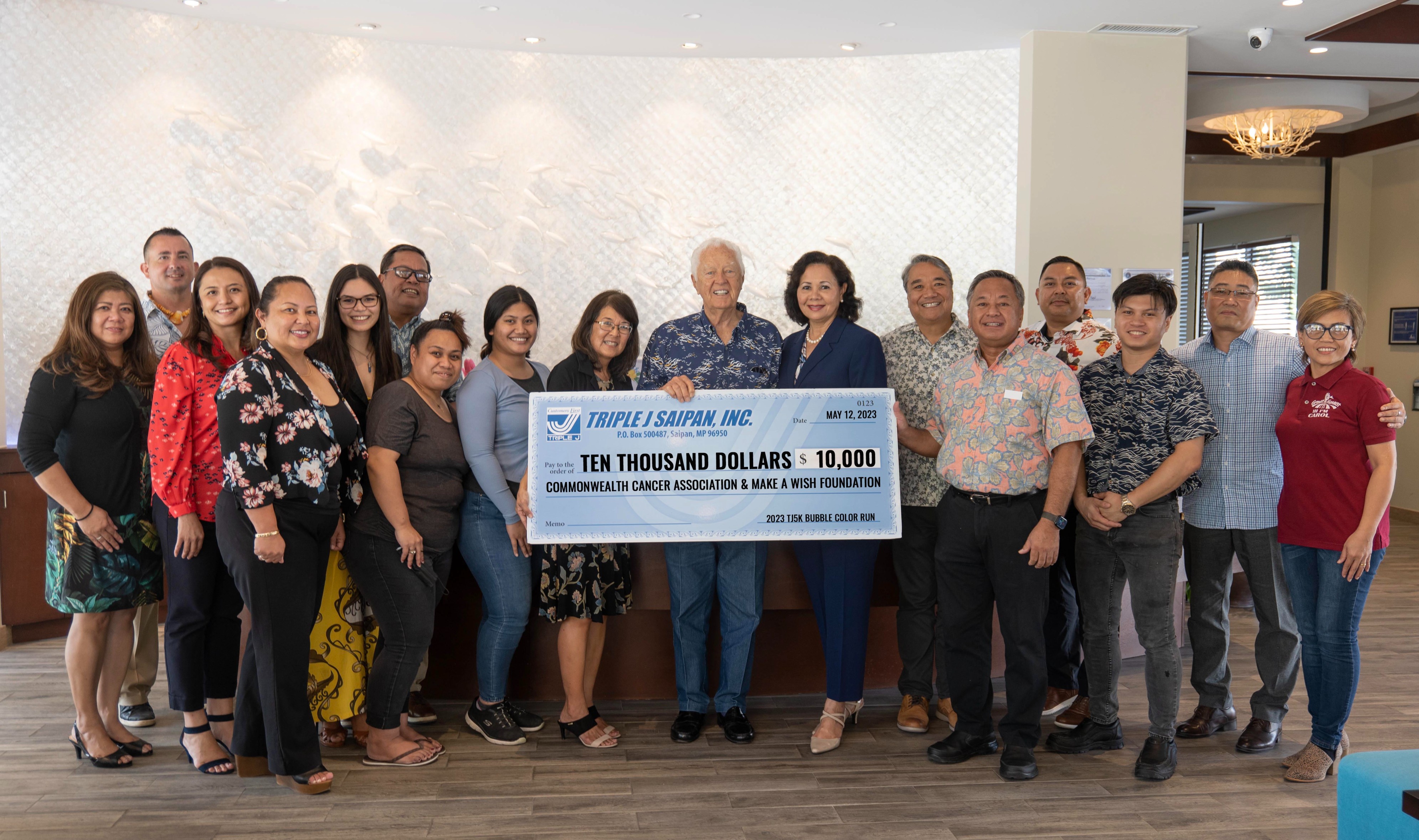 Triple J Enterprises, Inc. Chairman and CEO Robert H. Jones and wife Pilar present the Commonwealth Cancer Association and the Make-A-Wish Foundation a total of $10,000 following the successful return of the Triple J Bubble Color Run 5K.