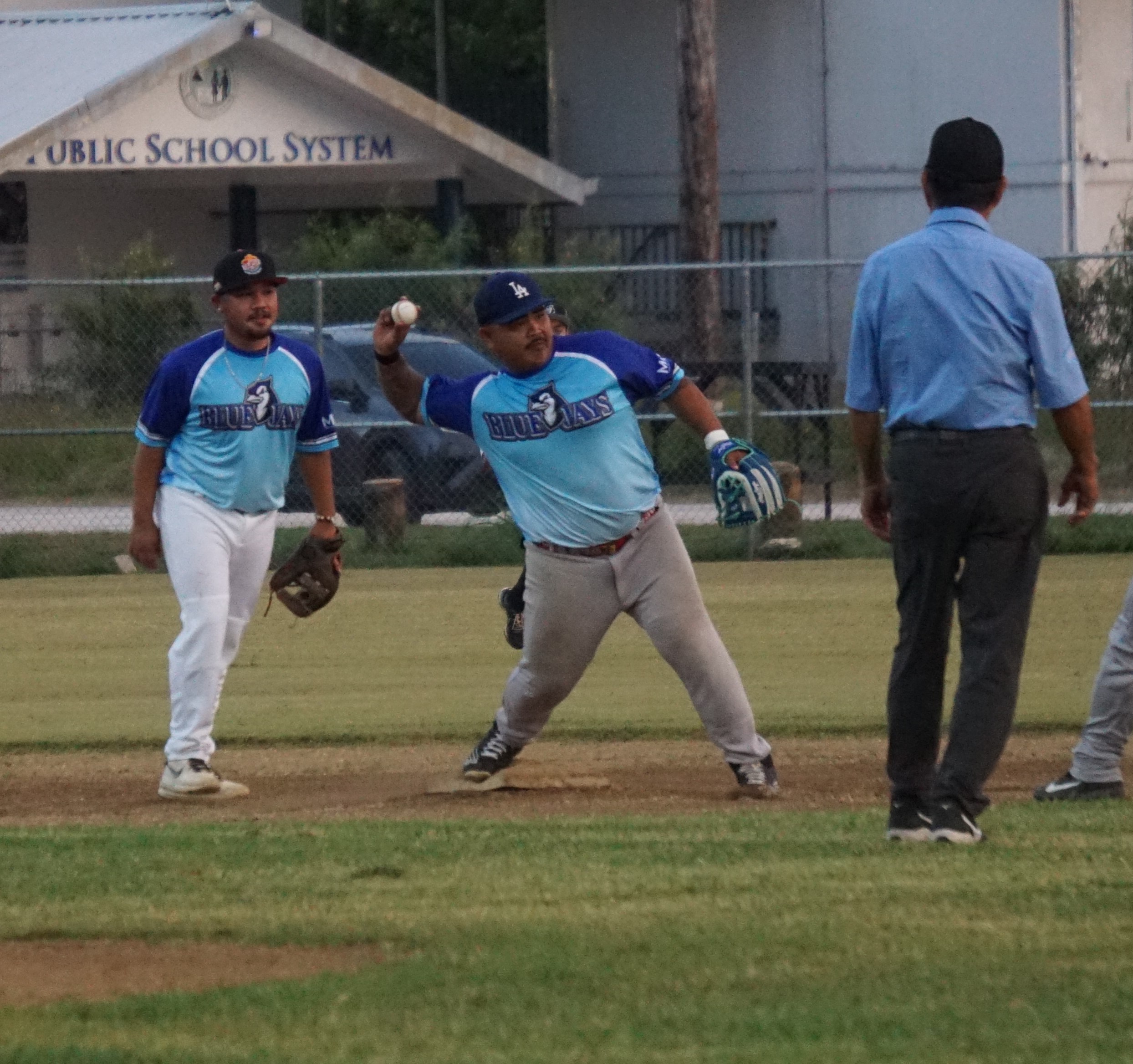 Blue Jays shortstop Kier Agda attempts the throw to first base for the double play during a 2023 Tan Holdings Saipan Baseball League game at the Francisco "Tan Ko" Palacios Baseball Field.