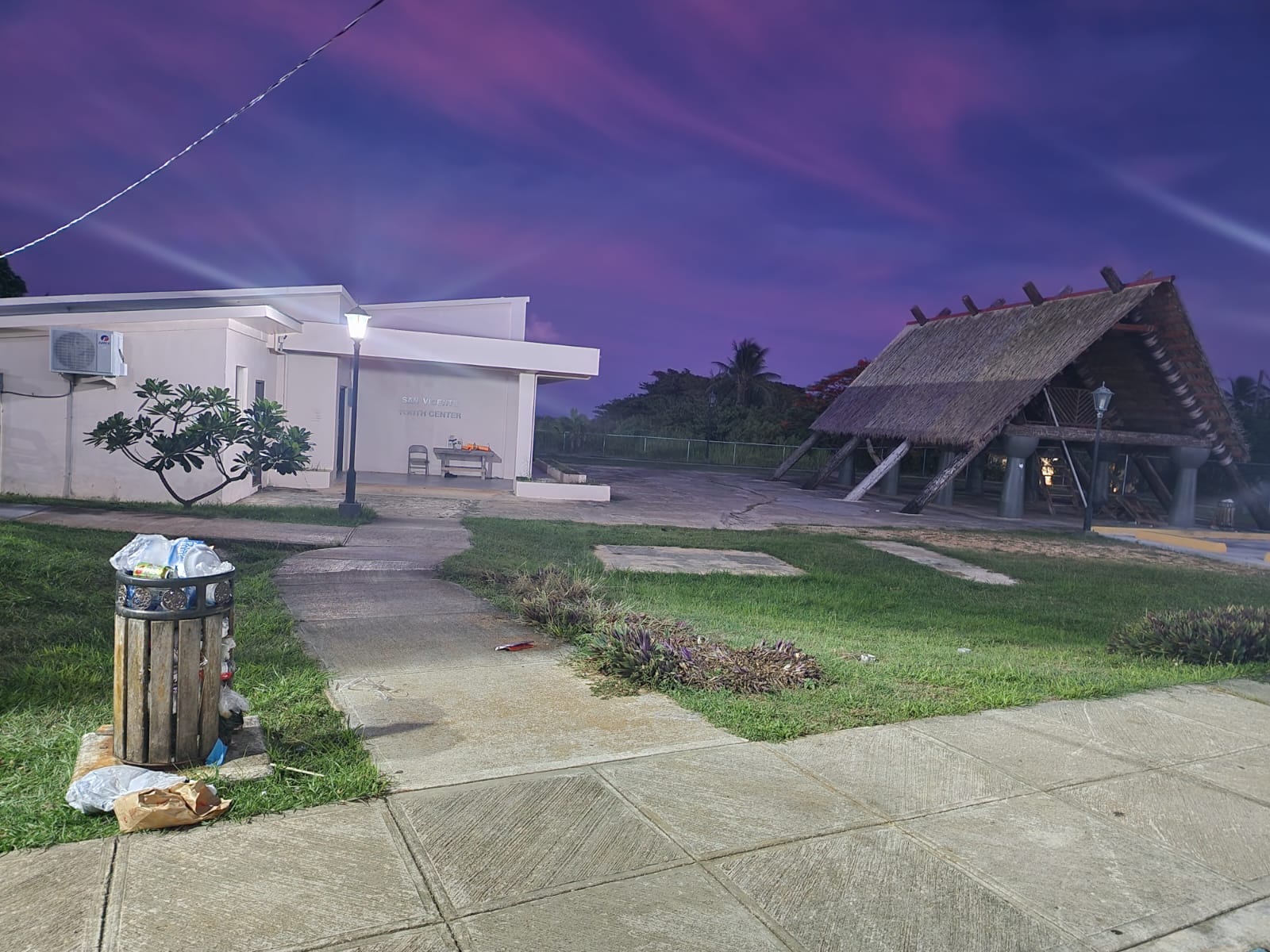 The sign stating that the National Guard has adopted San Vicente Central Park has been replaced by a garbage container filled with trash.