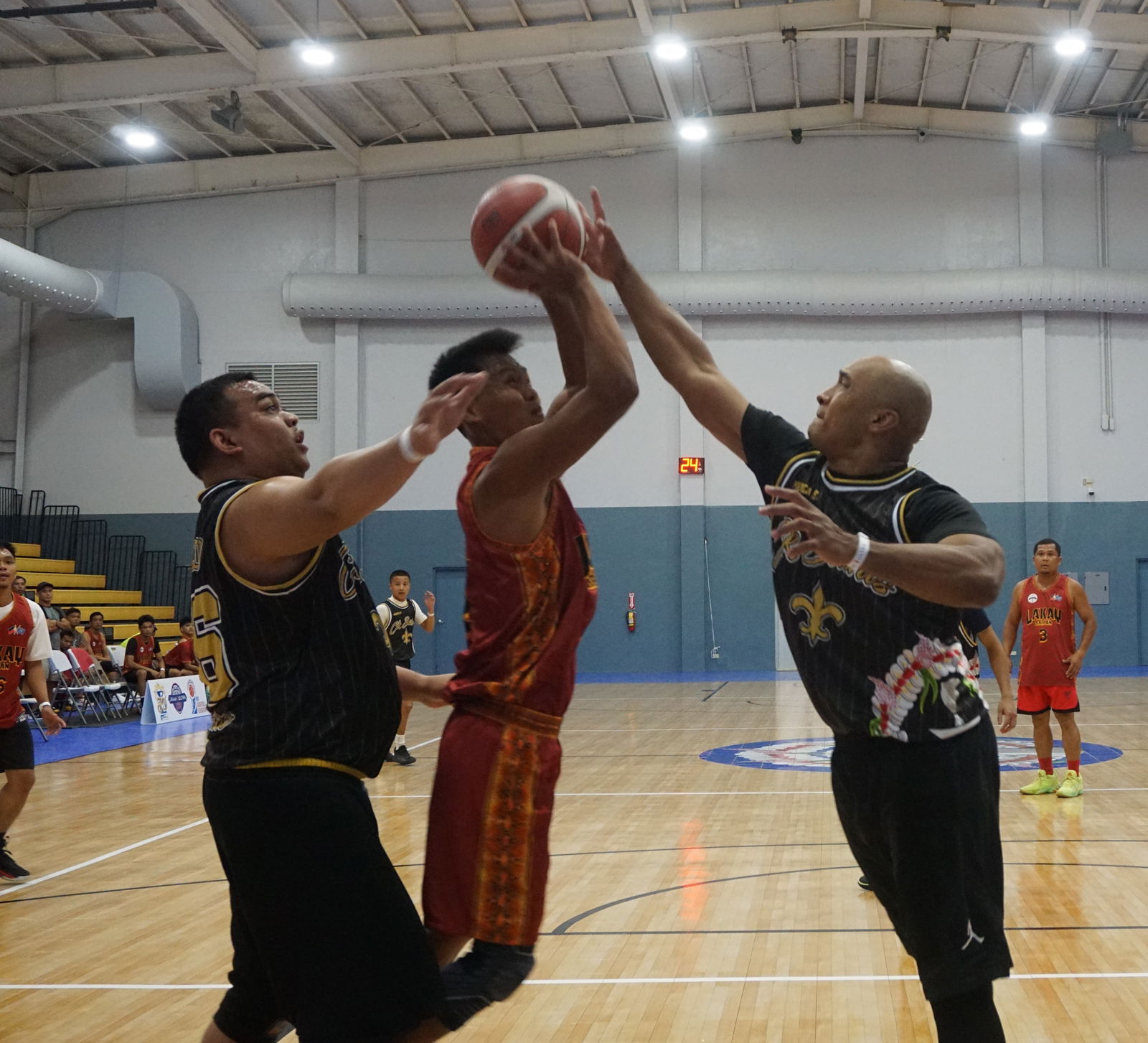 The CK Saints’ Damien Deleon Guerrero reaches out for the block in a Michelob Ultra Cup game at the Ada gym.