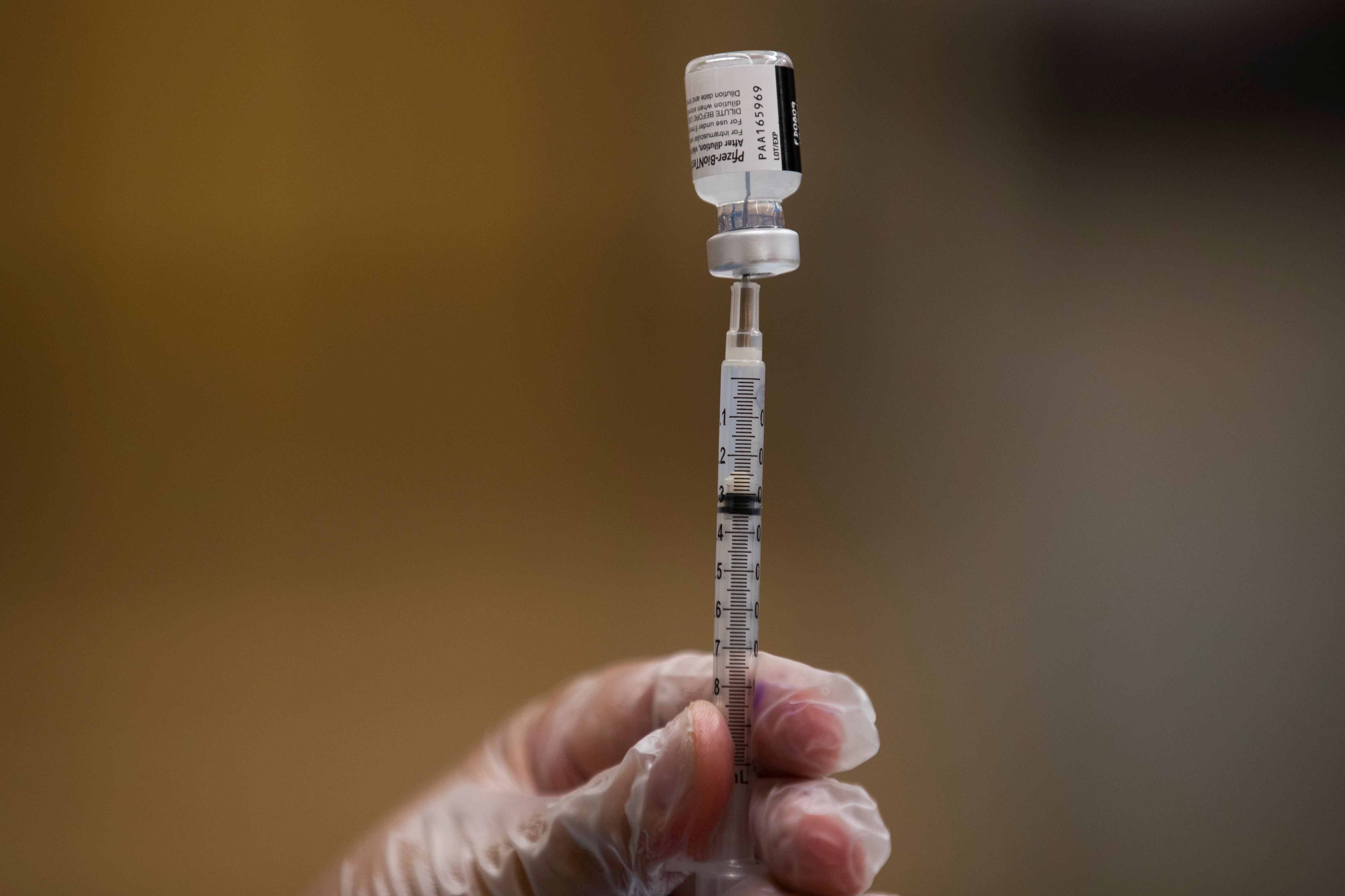 FILE PHOTO: A nurse fills a syringe with Pfizer vaccine as mobile vaccination teams begin visiting every Los Angeles Unified middle and high school campus to deliver first and second doses of the coronavirus disease (COVID-19) vaccines in Los Angeles, California, U.S., August 30, 2021. REUTERS/Mike Blake