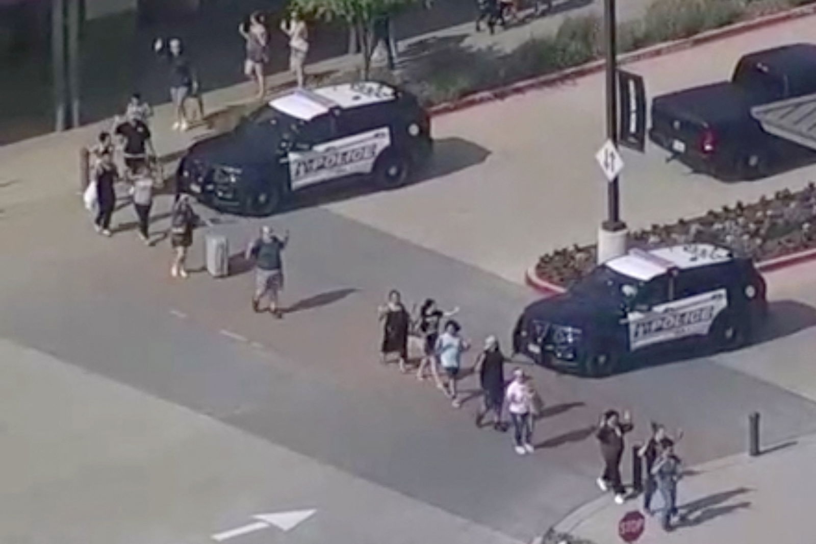 Shoppers leave with hands up as police respond to a shooting in the Dallas area's Allen Premium Outlets, which authorities said has left multiple people injured in Allen, Texas, U.S. May 6, 2023 in a still image from video. ABC Affiliate WFAA via REUTERS