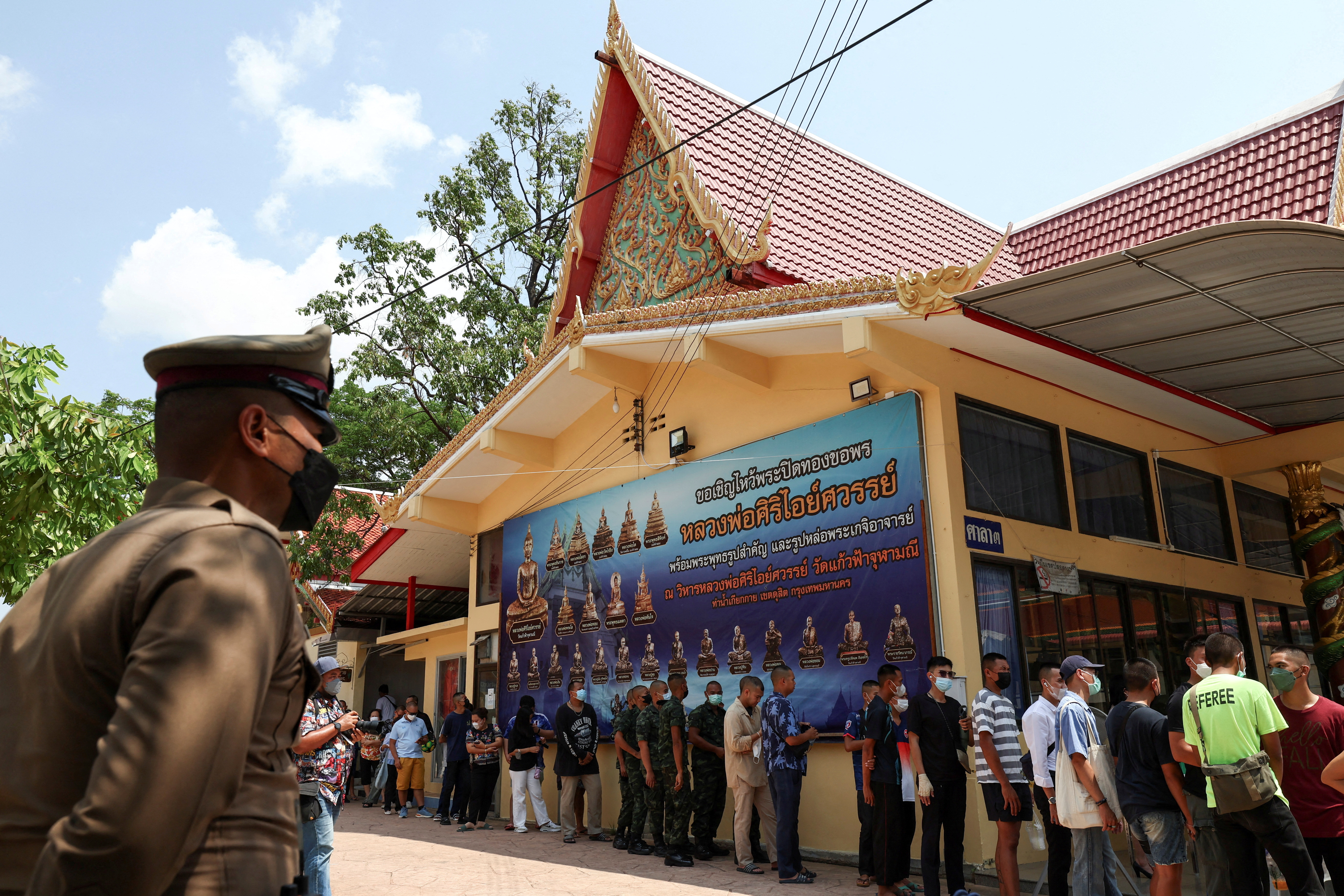 Voters stand in a queue to cast their ballot to vote in the general election at a polling station in Bangkok, Thailand, May 14, 2023. REUTERS/Athit Perawongmetha TPX IMAGES OF THE DAY