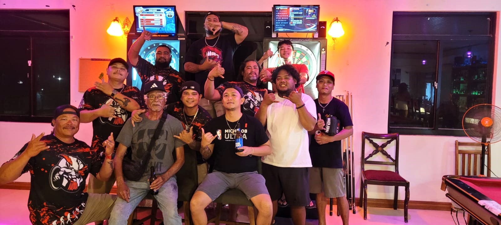 The 9Eleven Garapan Chura Boyz and the Spicy Thai Spartans A pose for a photo after their game in the A Division of the 2023 SEDA Bud Light Dart League at the Spicy Thai Restaurant.