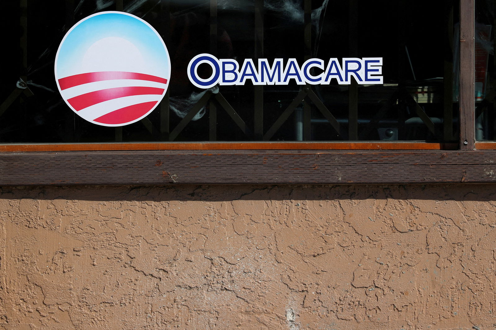 FILE PHOTO: A sign on an insurance store advertises Obamacare in San Ysidro, San Diego, California, U.S., October 26, 2017. REUTERS/Mike Blake