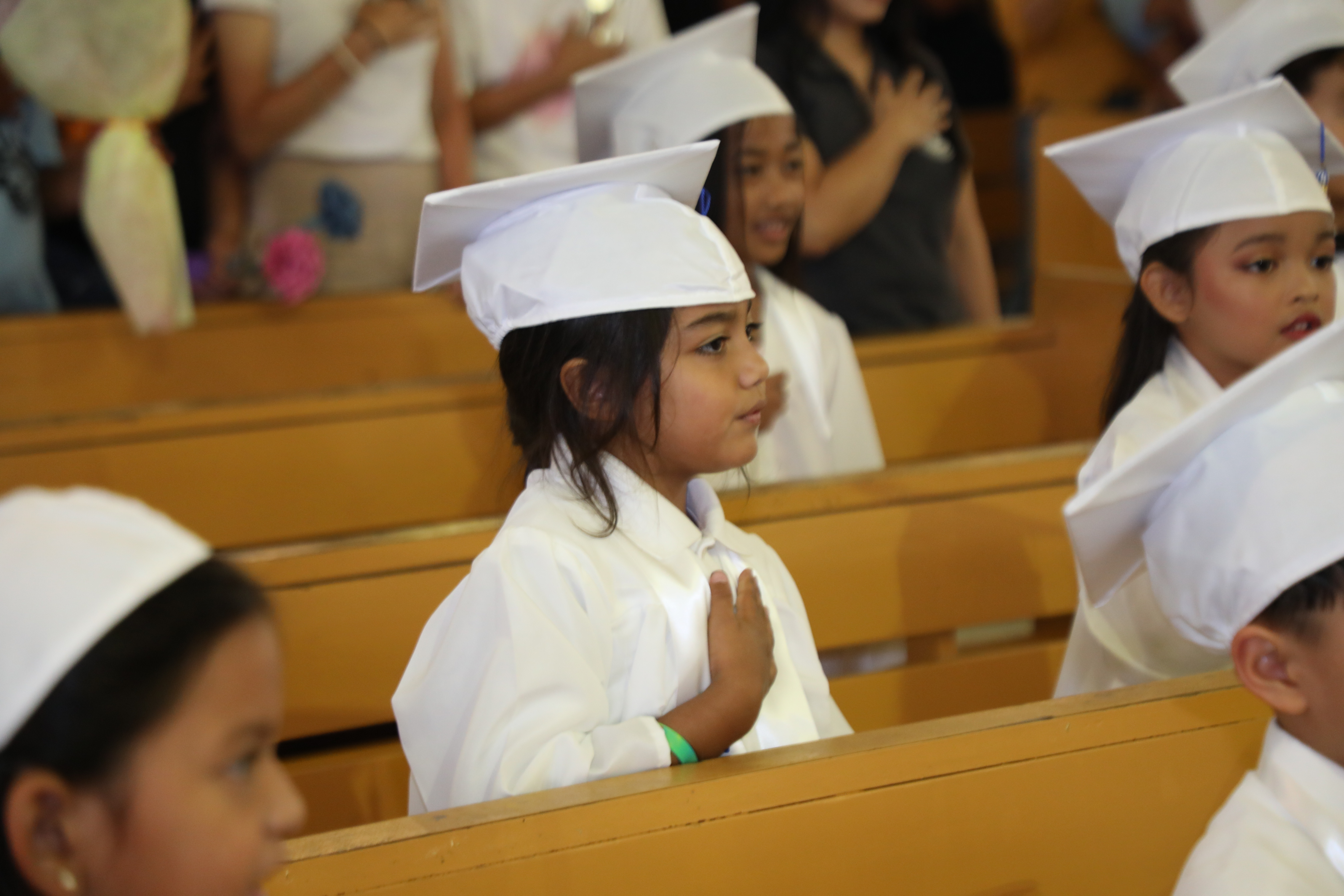 Mount Carmel School’s kindergarten graduates proudly sang the CNMI and national anthems during a traditional promotion ceremony at the Mount Carmel Cathedral.