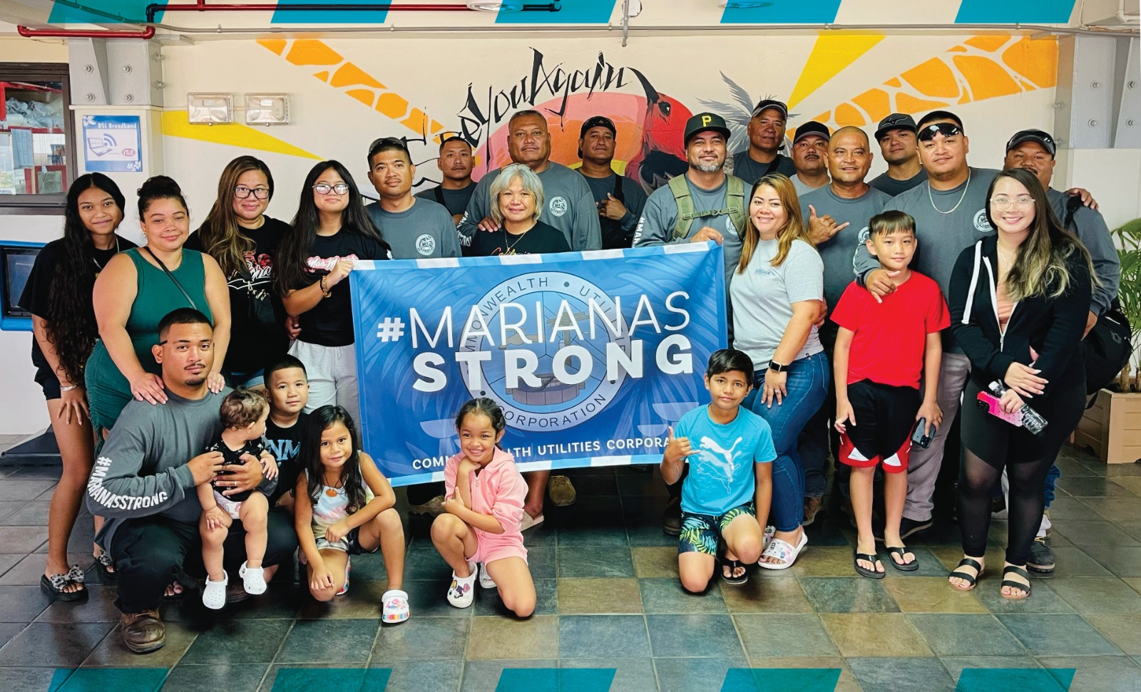 The Commonwealth Utilities Corporation line crewmembers headed to Guam pose for a photo with their family members at the Saipan airport.