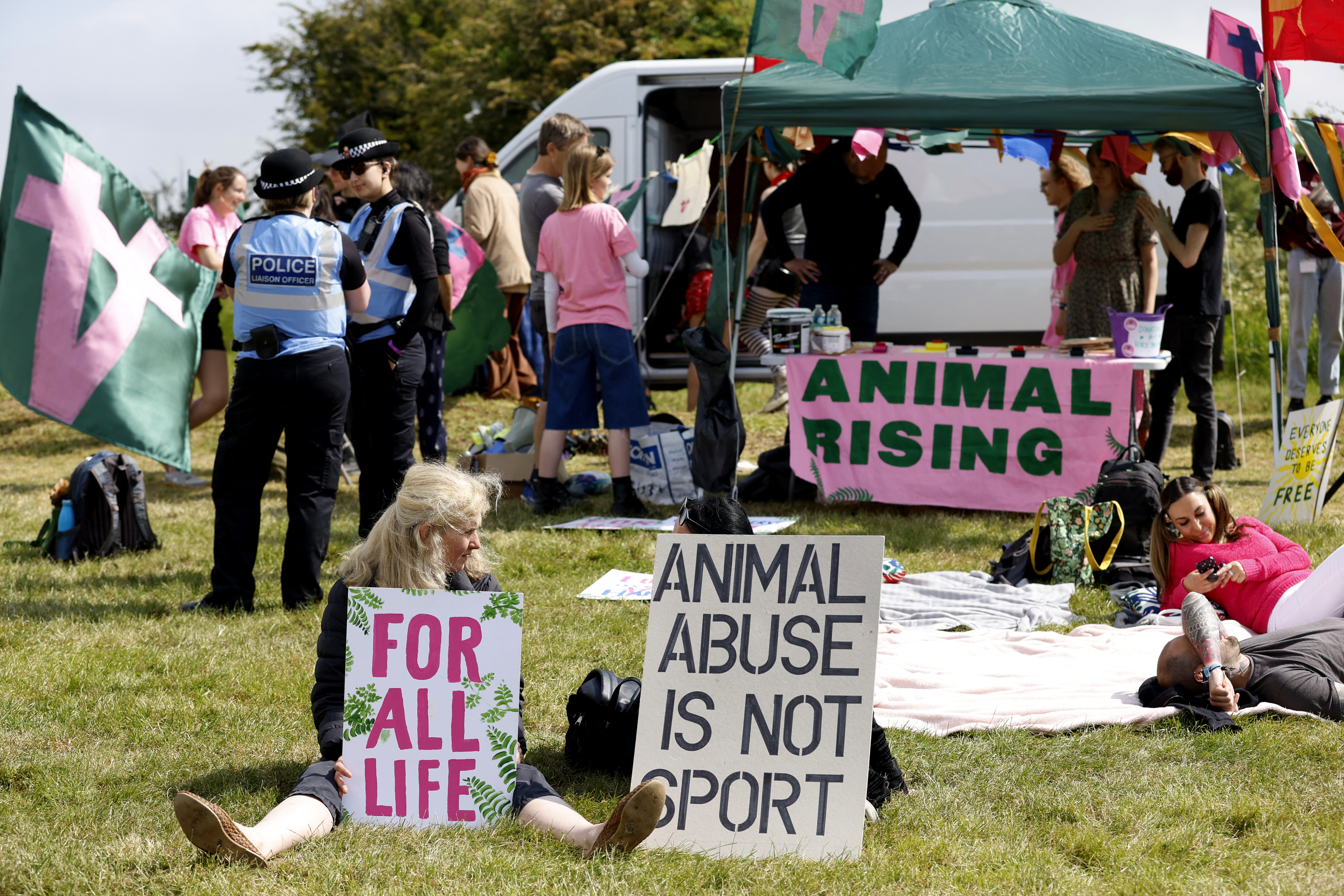 Horse Racing - Epsom Derby Festival - Epsom Downs Racecourse, Epsom, Britain - June 3, 2023 Animal Rising activists display signs to protest before the start of the Epsom Derby Festival Action Images via Reuters/Peter Cziborra