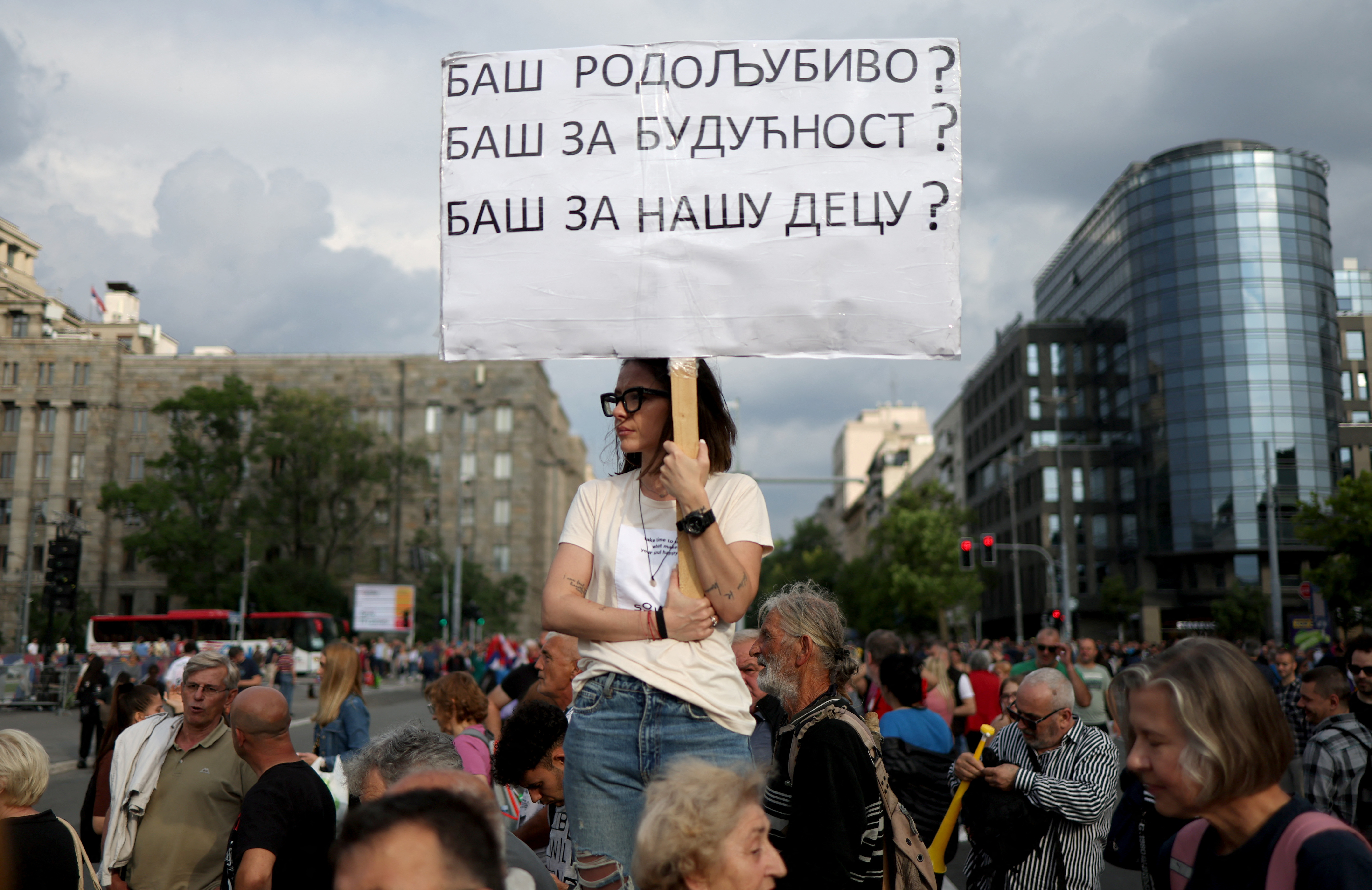 People attend a demonstration "Serbia against violence" organized by Serbia's opposition parties in reaction to the two mass shootings in the same week, in Belgrade, Serbia, June 17, 2023. The banner reads "Really patriotic? Really for the future? Really for our children?" REUTERS/Marko Djurica