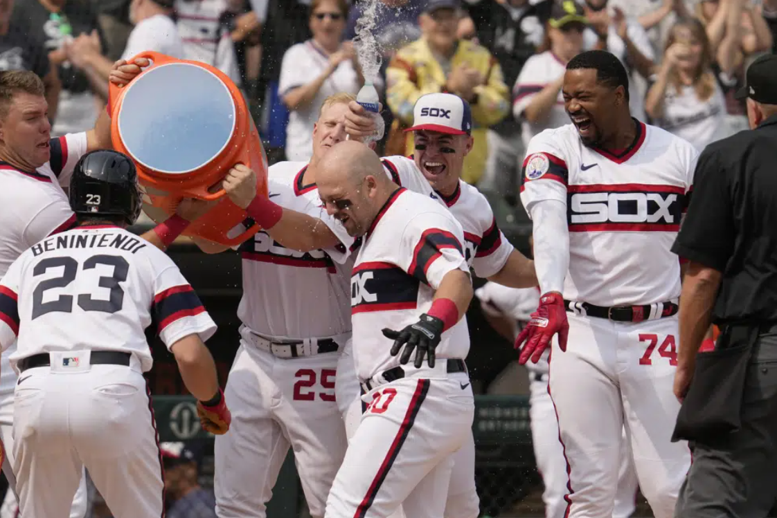 Chicago White Sox's Jake Burger (30), center, is congratulated by teammates after hitting a grand slam during the ninth inning of a baseball game against the Detroit Tigers in Chicago, Sunday, June 4, 2023.