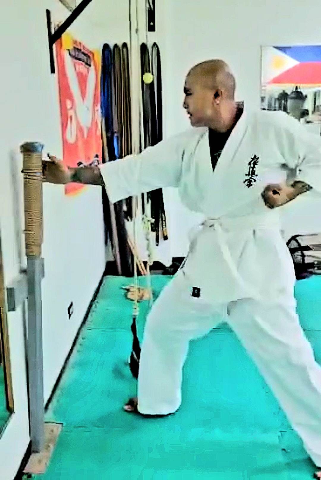Jerry Diaz refines his technical striking skills using a traditional makiwara board.