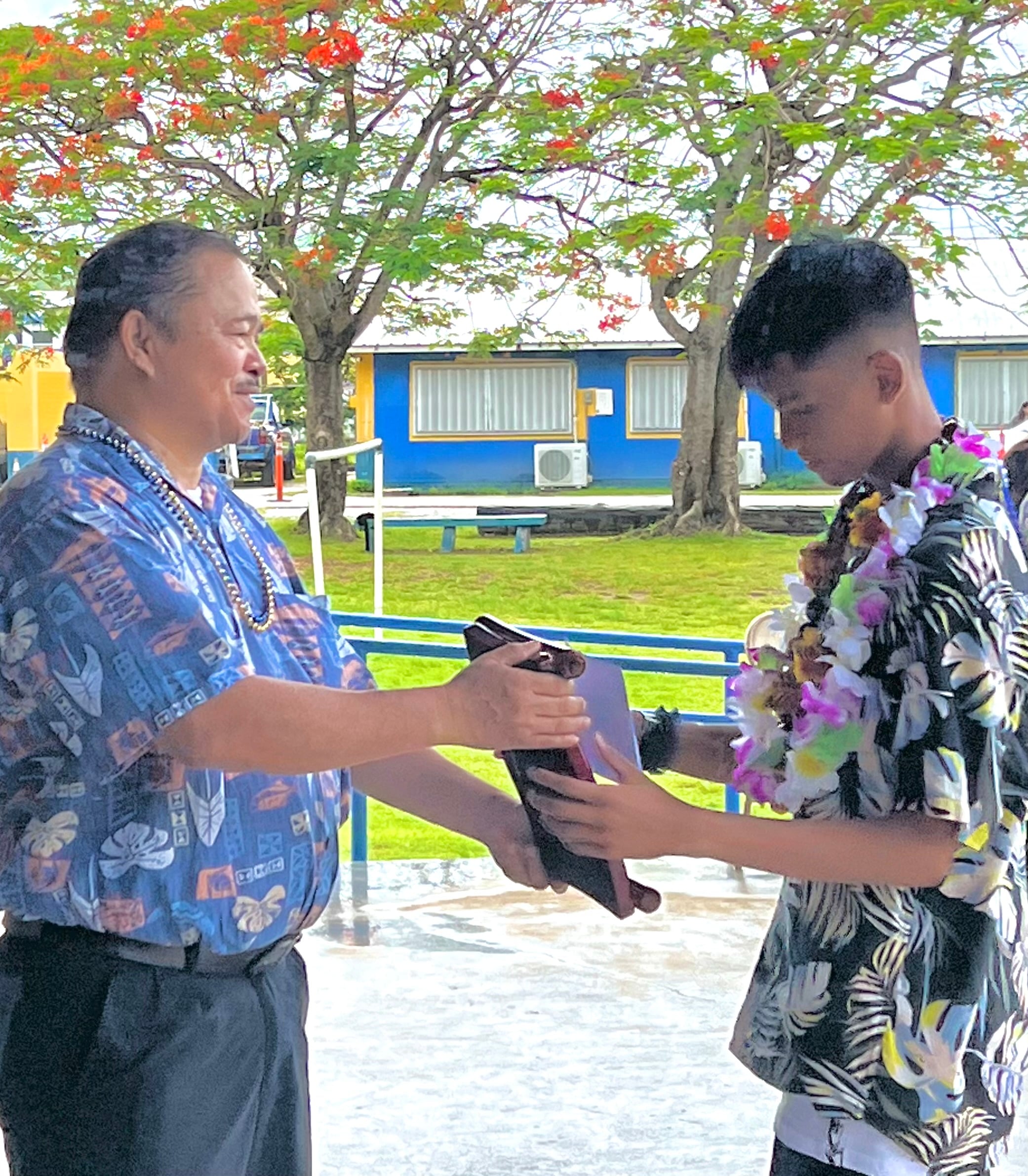 Class salutatorian Adrian Mallari Lubao receives his award from Commissioner of Education Dr. Alfred B. Ada