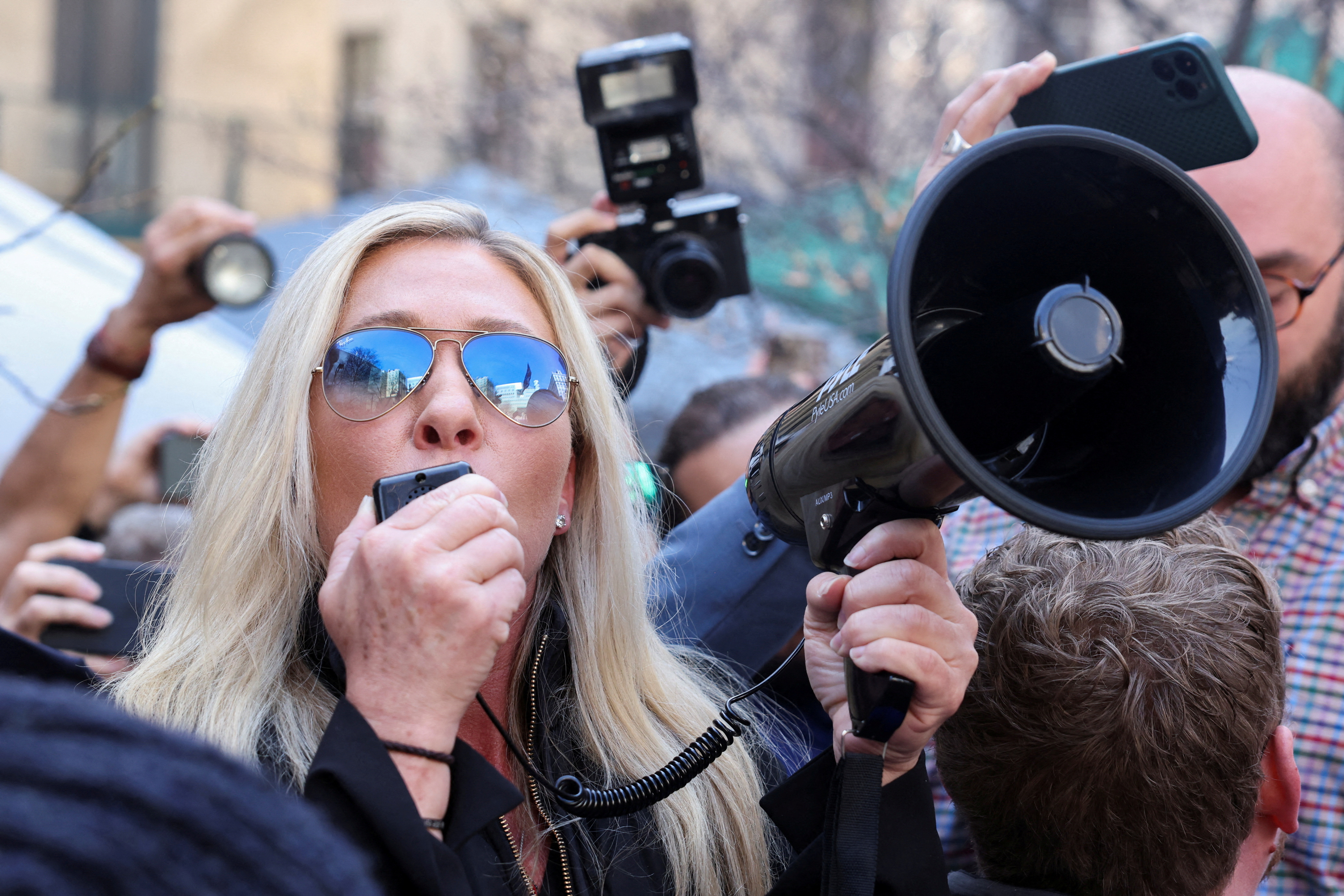 FILE PHOTO: U.S. Rep. Marjorie Taylor Greene (R-GA) speaks outside Manhattan Criminal Courthouse on the day of former U.S. President Donald Trump's court appearance after his indictment by a Manhattan grand jury following a probe into hush money paid to porn star Stormy Daniels, in New York City, U.S., April 4, 2023. REUTERS/Caitlin Ochs/File Photo