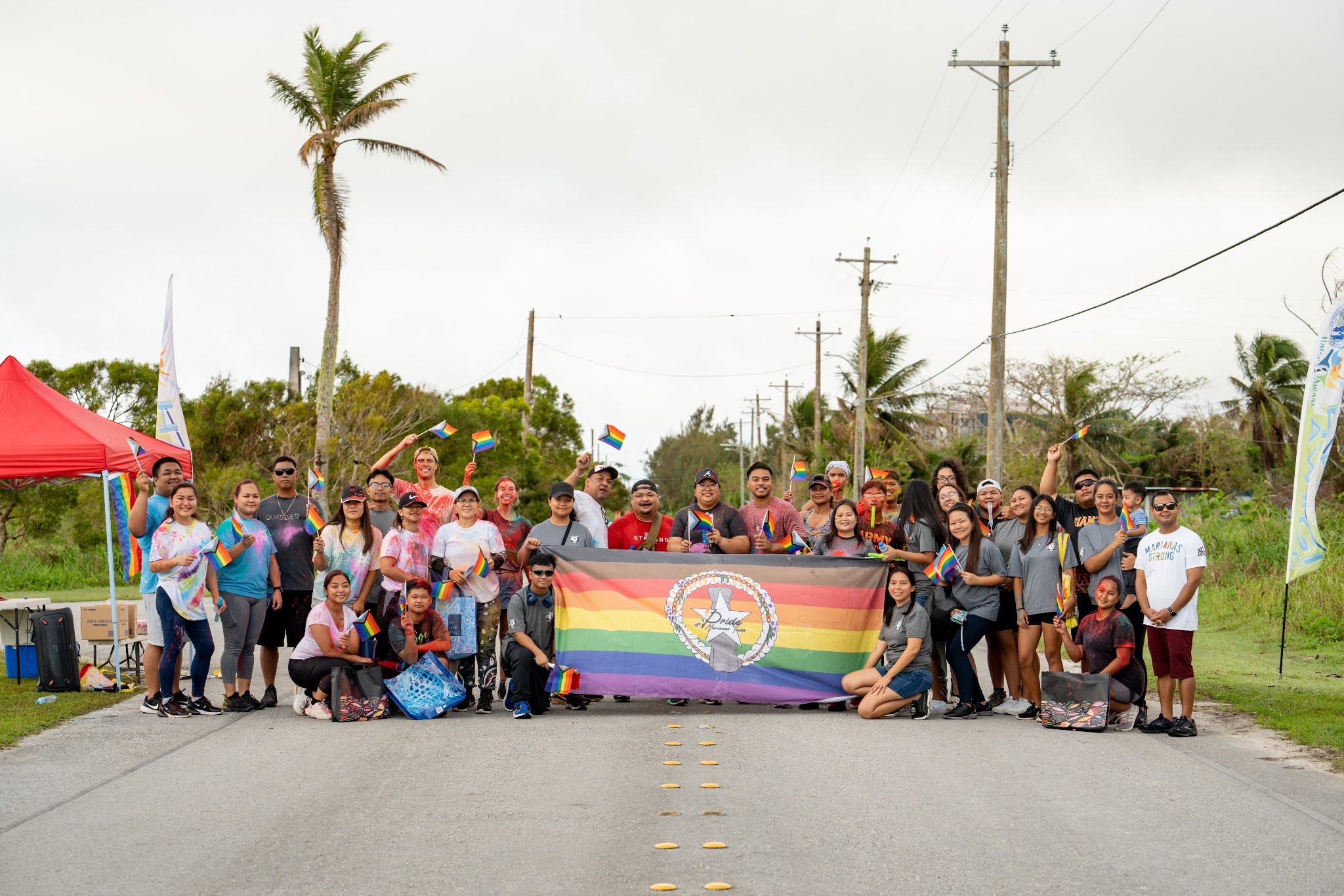 PSS Mental Health Team poses with Rota Mayor Aubry Hocog, Luta Color Run participants, and AmeriCorps volunteers at the finishing station of the run.