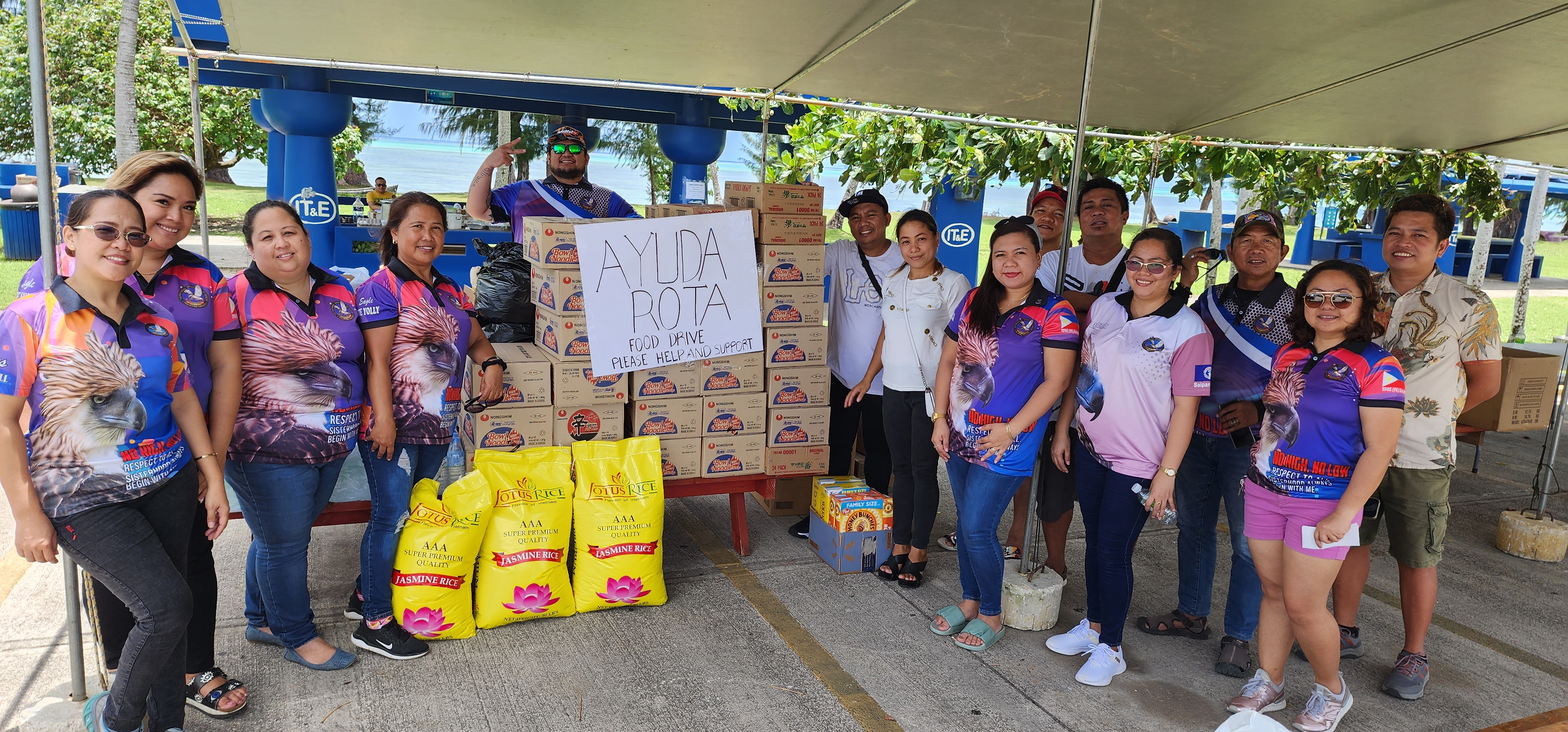 Saipan Eagles Club members and volunteers accept in-kind donations from community members for the Ayuda Rota Food Drive at the Kilili Pavilion on Sunday.