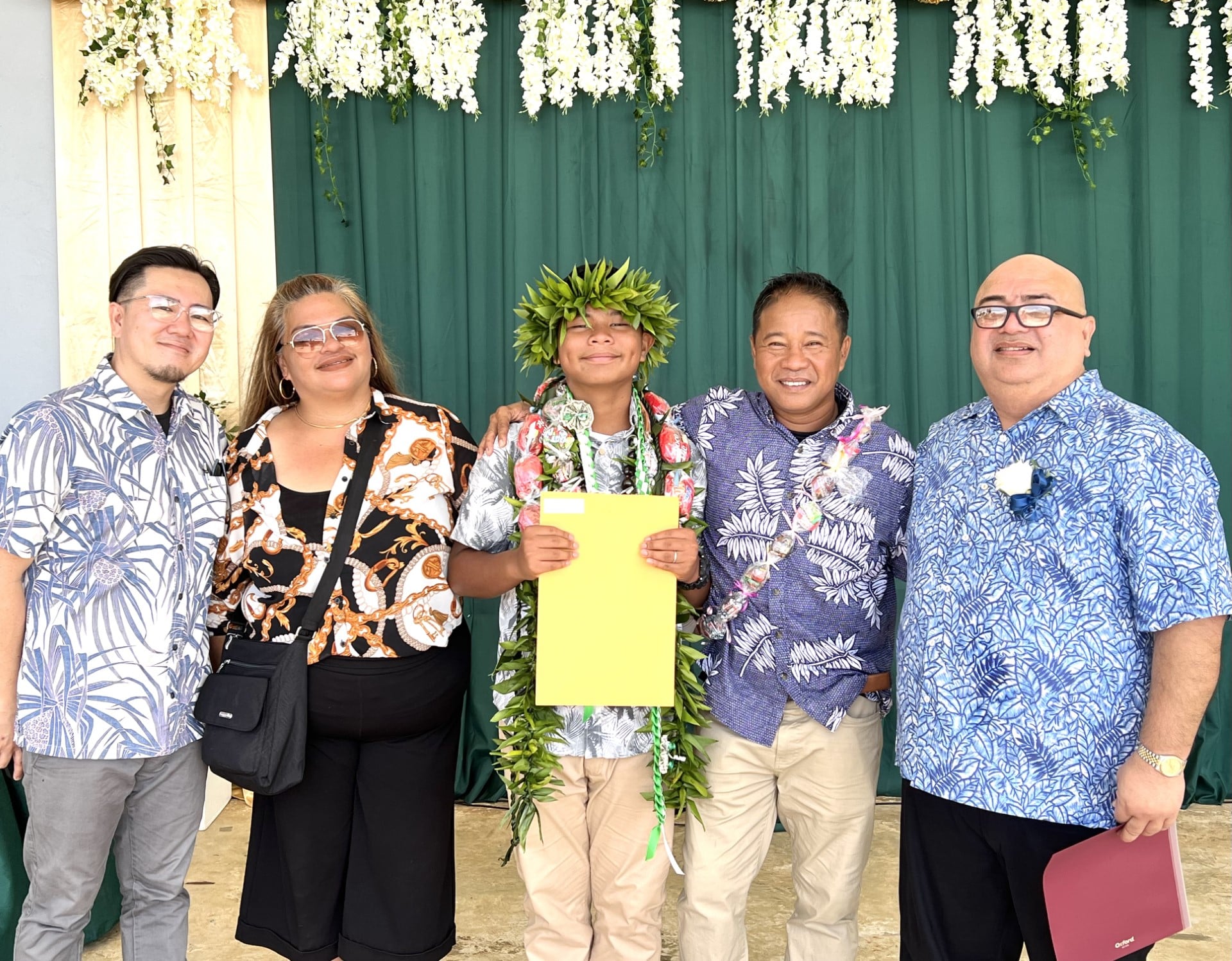 Newly promoted Dandan Middle School student Colton John D. Guinto with proud parents Dorsha and Ed Guinto, DMS Principal James Sablan and Vice Principal Reo Arriola.