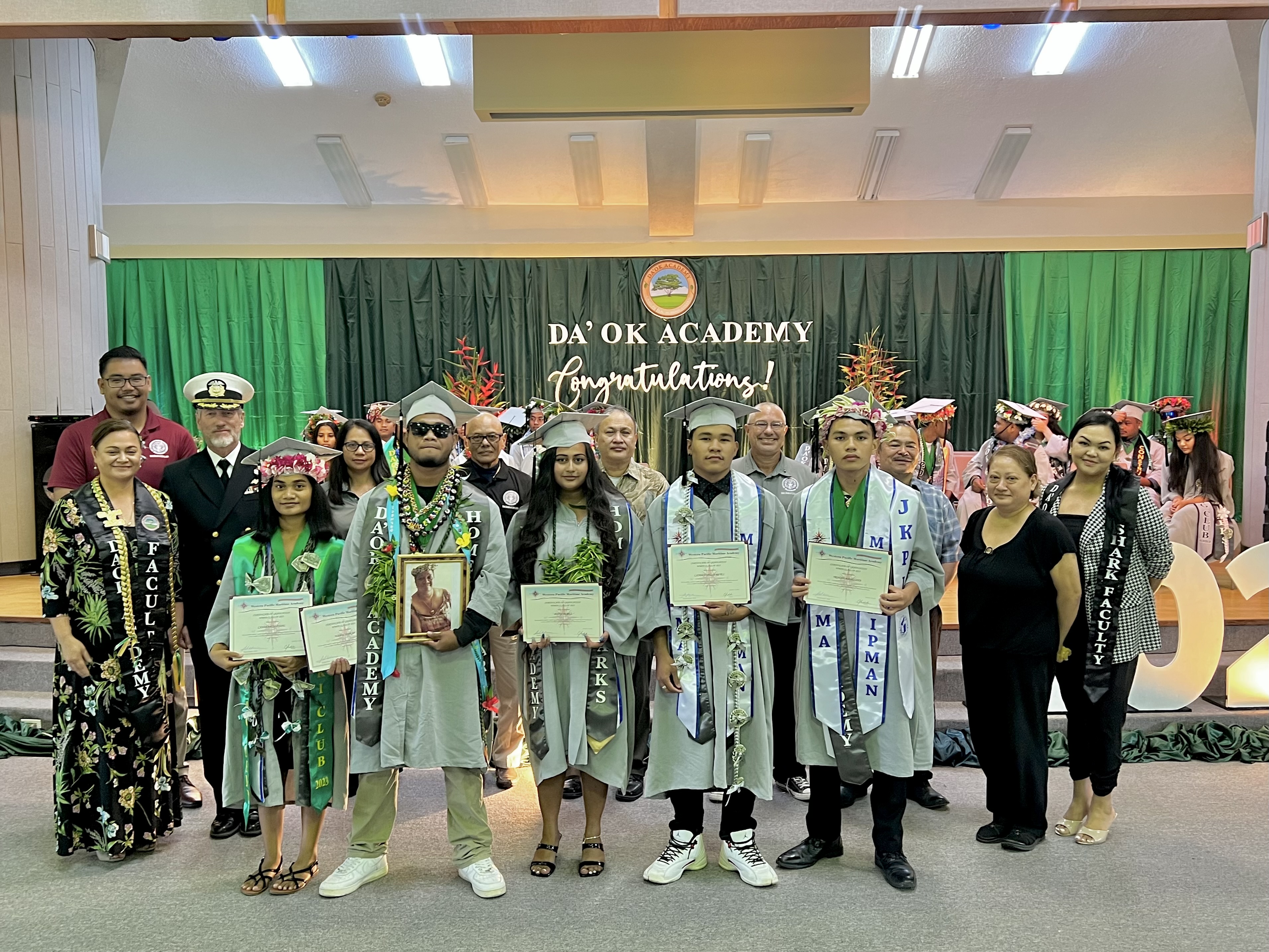 Anita Perez, Tristan Manglona, Simkap Wabol, Canfrancia Fitial, and Landon Delos Reyes completed the merchant marine program in partnership with the Western Pacific Mariners Academy. Joining them in the photo are Captain Michael Bacher of the Western Pacific Mariners Academy, PSS CTE Director Dr. Jessica Taylor, Da’ok Academy Principal Christine Tudela, Board of Education Chairman Antonio L. Borja, Vice Chairman Herman Atalig, Secretary/Treasurer Gregory Pat Borja, Member Maisie B. Tenorio, Member Andrew Orsini and Commissioner of Education Dr. Alfred B. Ada.