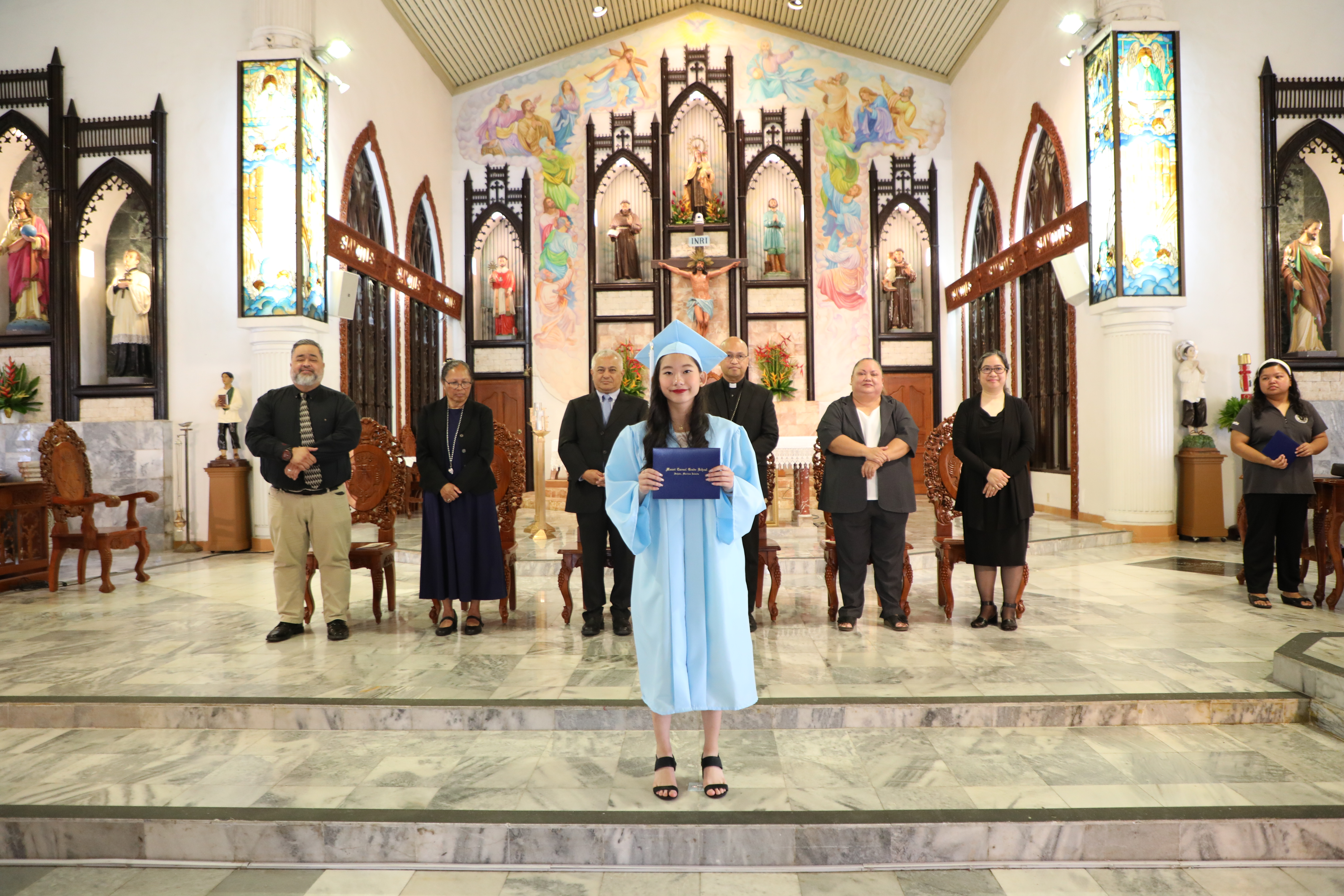 Mount Carmel School student Christine Doctolero Tamondong receives her diploma during the school’s 8th-Grade Promotion Ceremony on June 3, 2023.