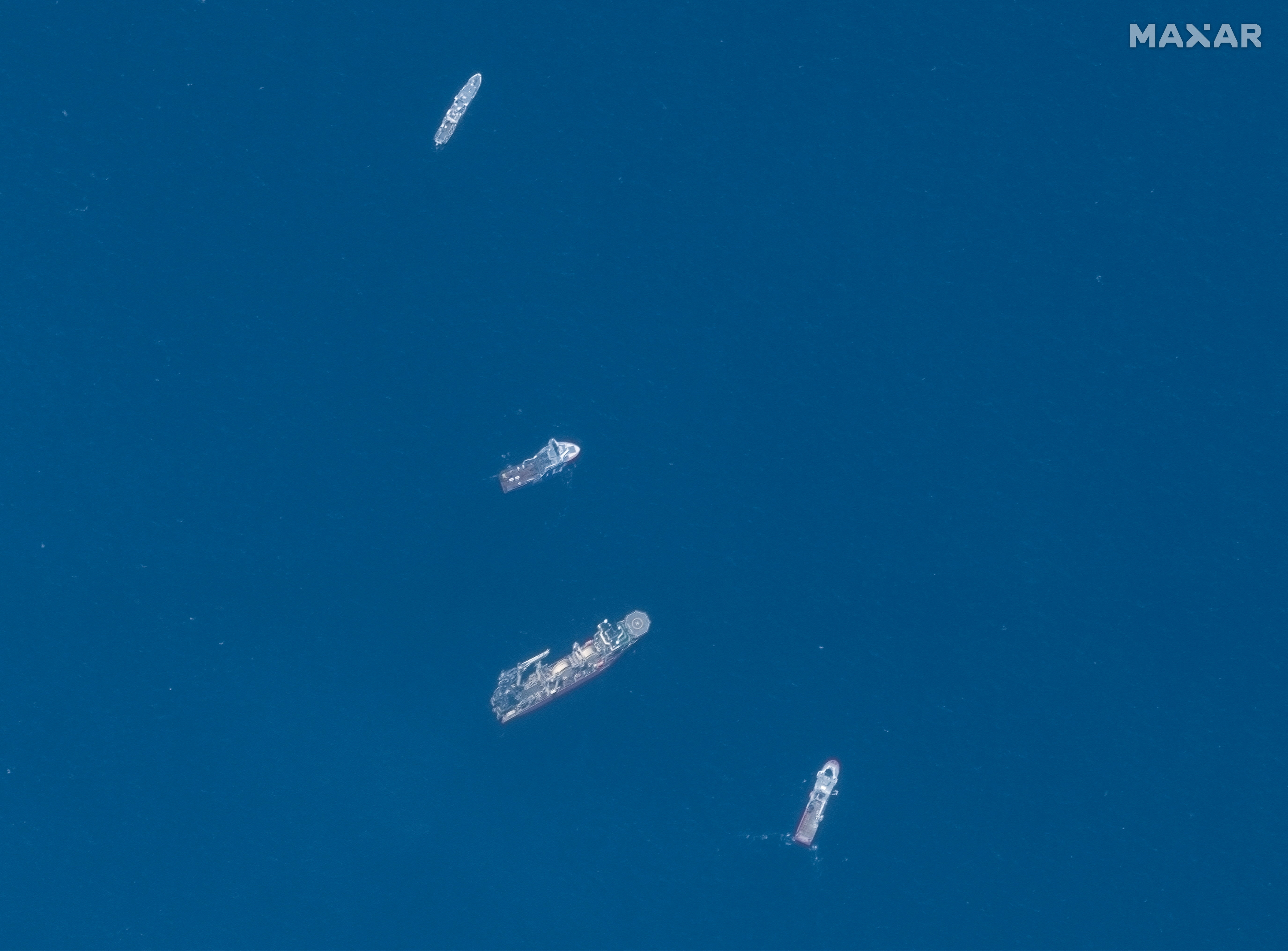 A satellite image shows ships taking part in the search and rescue operations associated with the missing Titan submersible near the wreck of the Titanic, June 22, 2023.