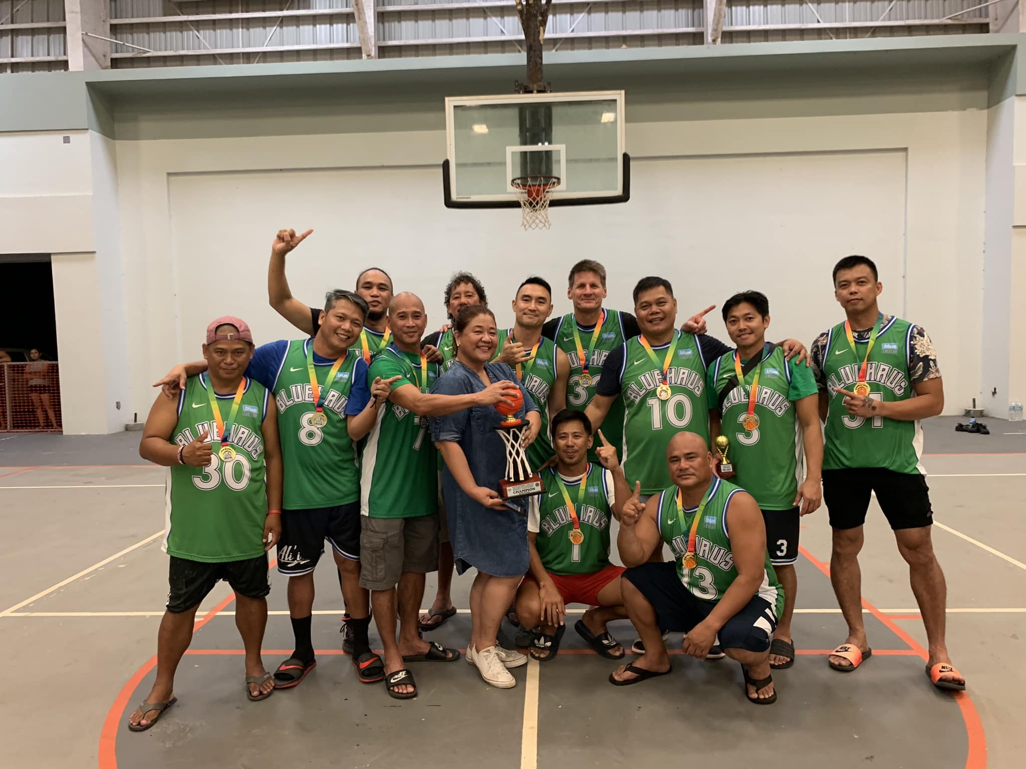 Members of team Blue Haus pose with the masters division championship trophy of the Saipan Centennial Lions Club Invitational Basketball League at the Koblerville gym on Tuesday.
