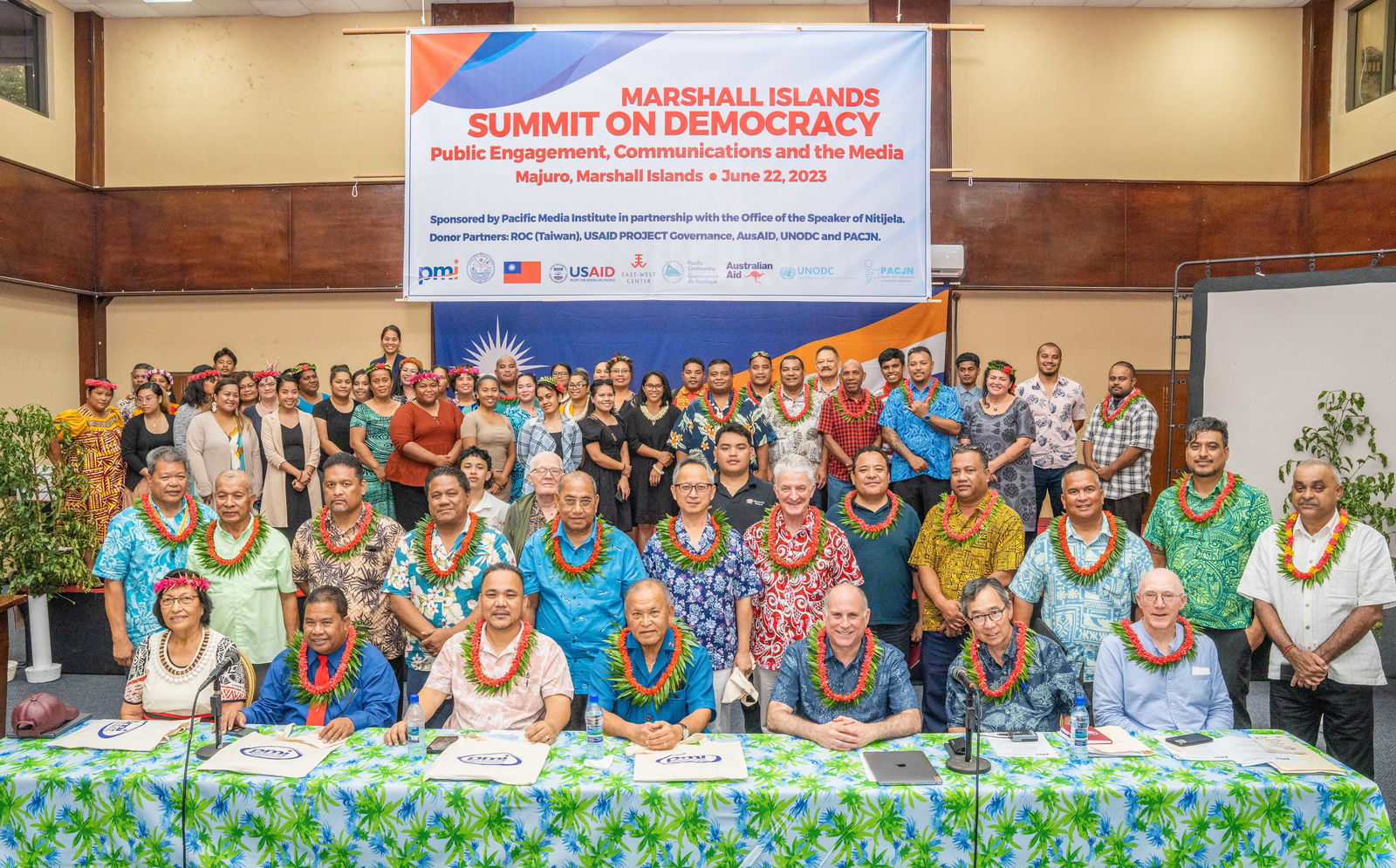 Marshall Islands President David Kabua, seated center, was joined at the opening of the Summit on Democracy by, from left: Ambassador Neijon Edwards, Rev. Jeledrik Binejal, Speaker Kenneth Kedi, keynote speaker Andy Winer, lead workshop trainer Floyd K. Takeuchi, and Pacific Media Institute co-founder Giff Johnson. At back are elected leaders and media workshop participants.