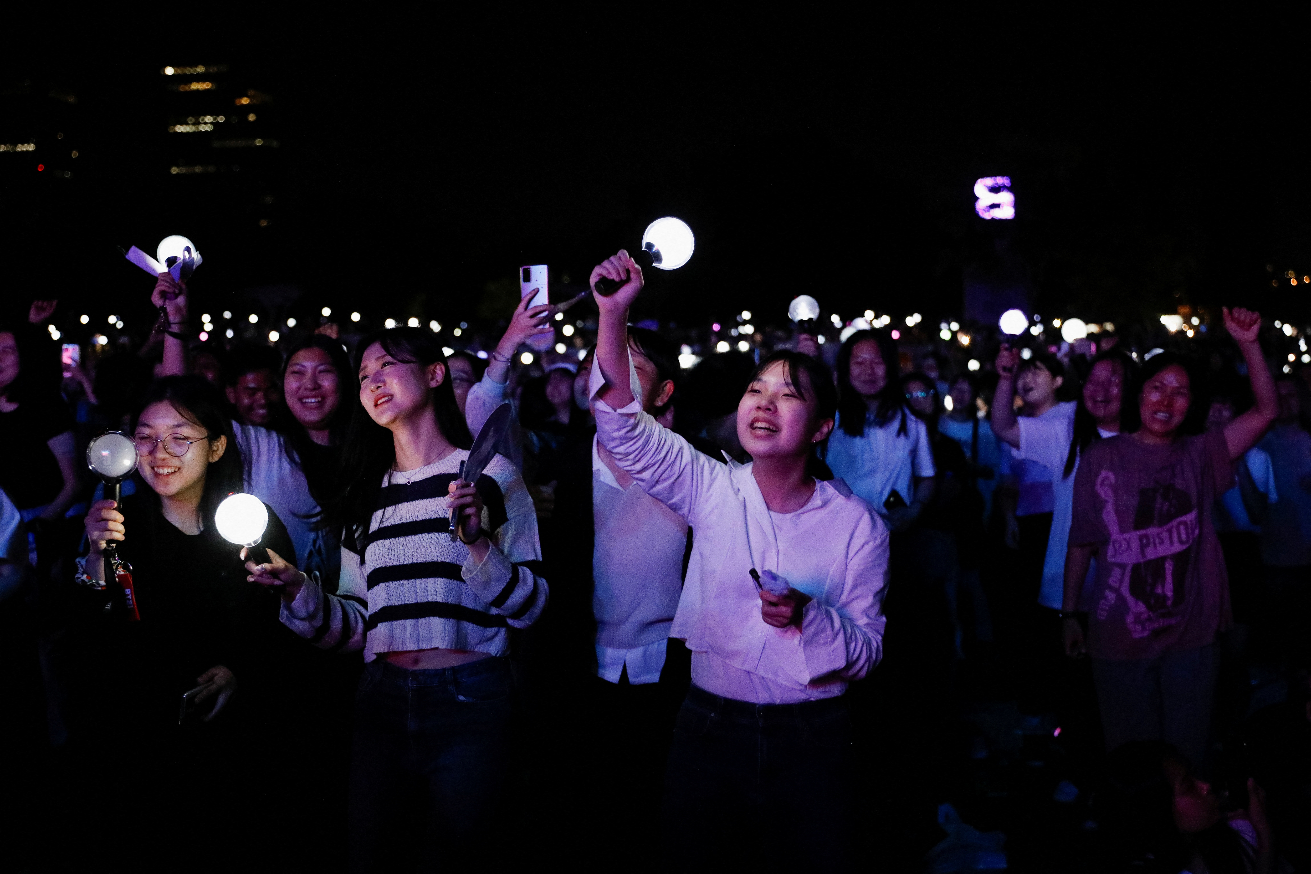 Fans of the K-pop boy band BTS dance during BTS 10th Anniversary FESTA in Seoul, South Korea, June 17, 2023. REUTERS/Kim Soo-hyeon