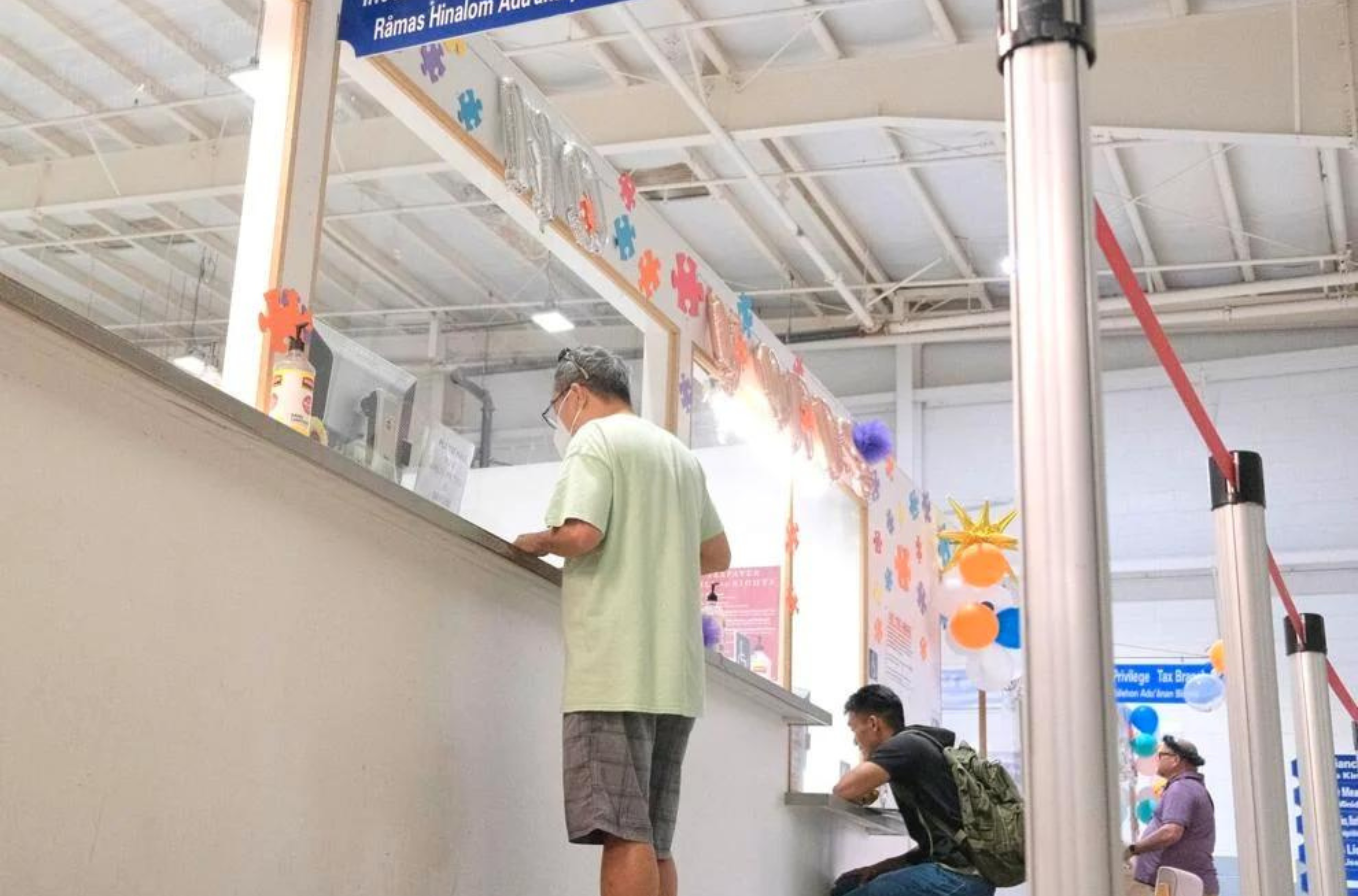 Customers are assisted with income tax services at the Department of Revenue and Taxation’s Income Tax and Processing Branch in Barrigada on April 26, 2023. 