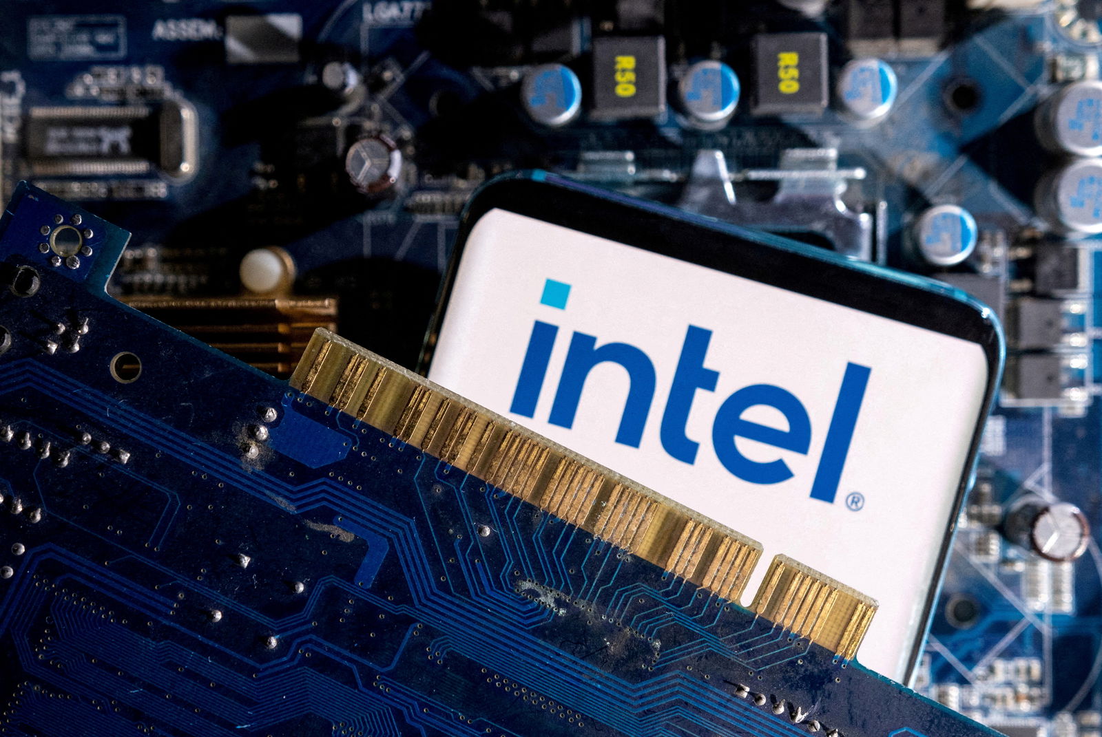 A smartphone with a displayed Intel logo is placed on a computer motherboard in this illustration taken on March 6, 2023.