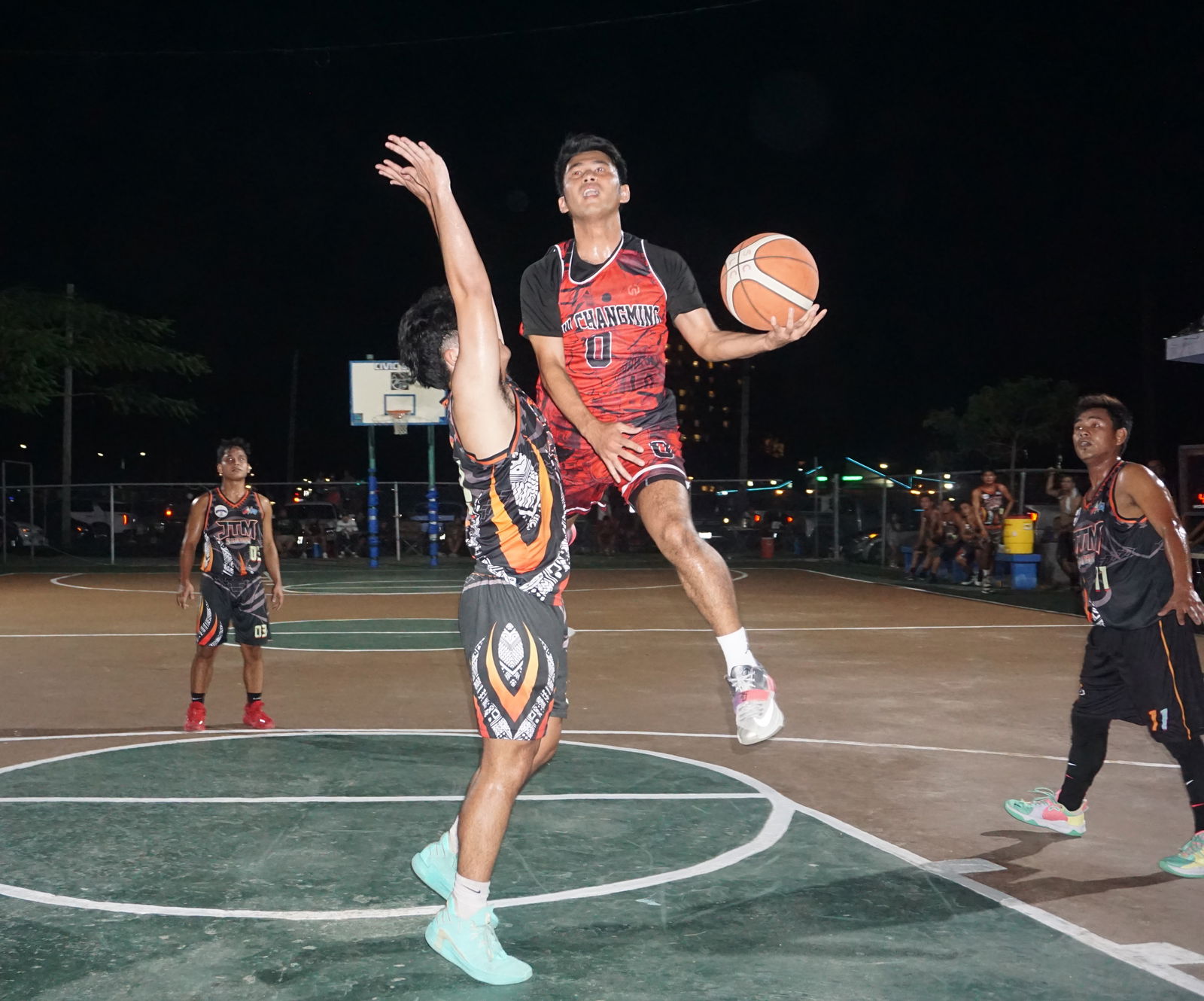 New Chang Ming's Keith Santos extends as he makes contact going for the layup during the quarterfinal game against JTM Saipan in the Saipan Centennial Lions Club Invitational Basketball League Friday at the Civic Center basketball court.