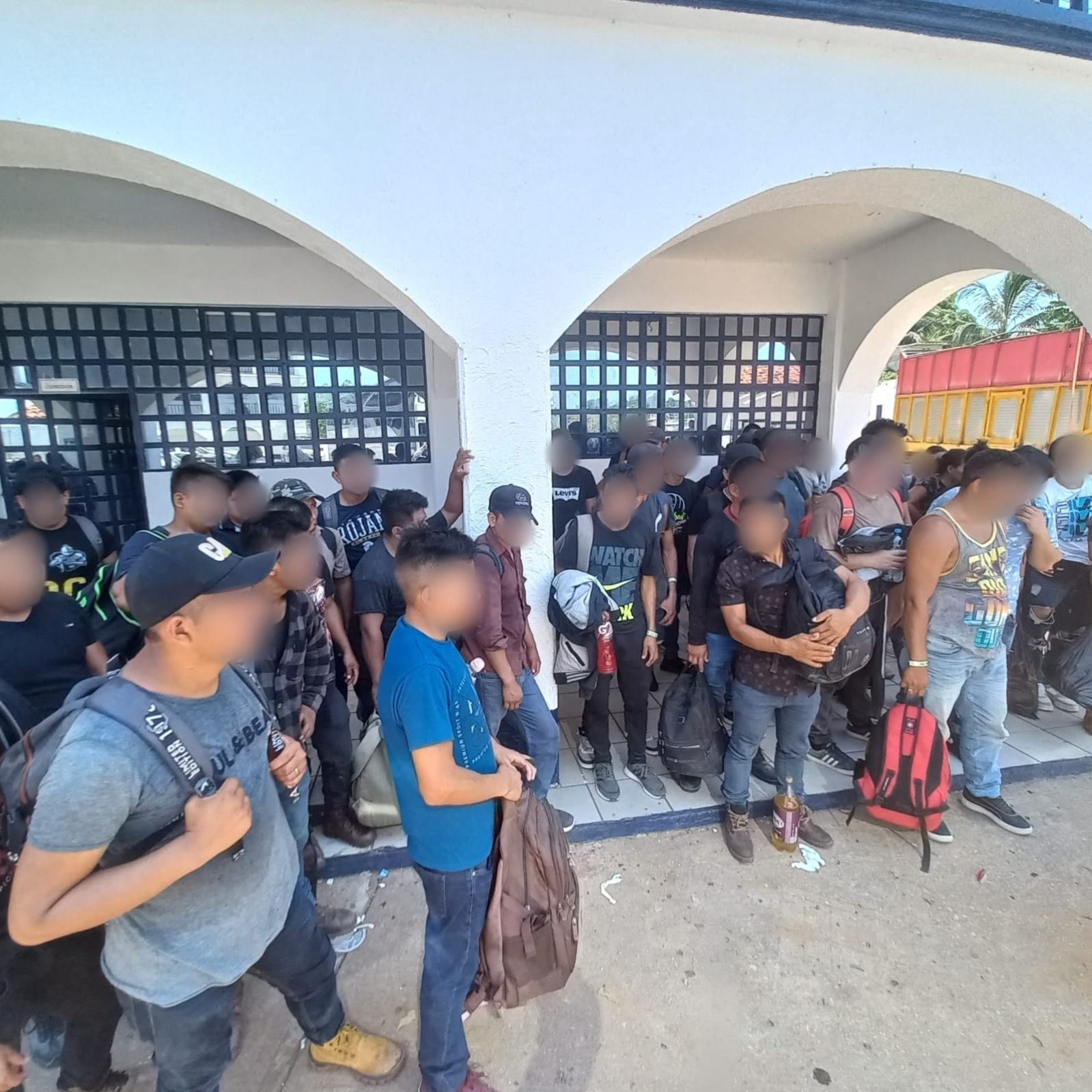 Migrants, who were part of a group of 129 migrants from Guatemala, Honduras, El Salvador and India who were located in the back of a Torton-type truck according to a statement by Mexico's National Institute of Migration (INM), stand in Sayula de Aleman, Veracruz, Mexico, in this photo released on June 16, 2023 and distributed by INM. Instituto Nacional De Migracion/Handout via REUTERS