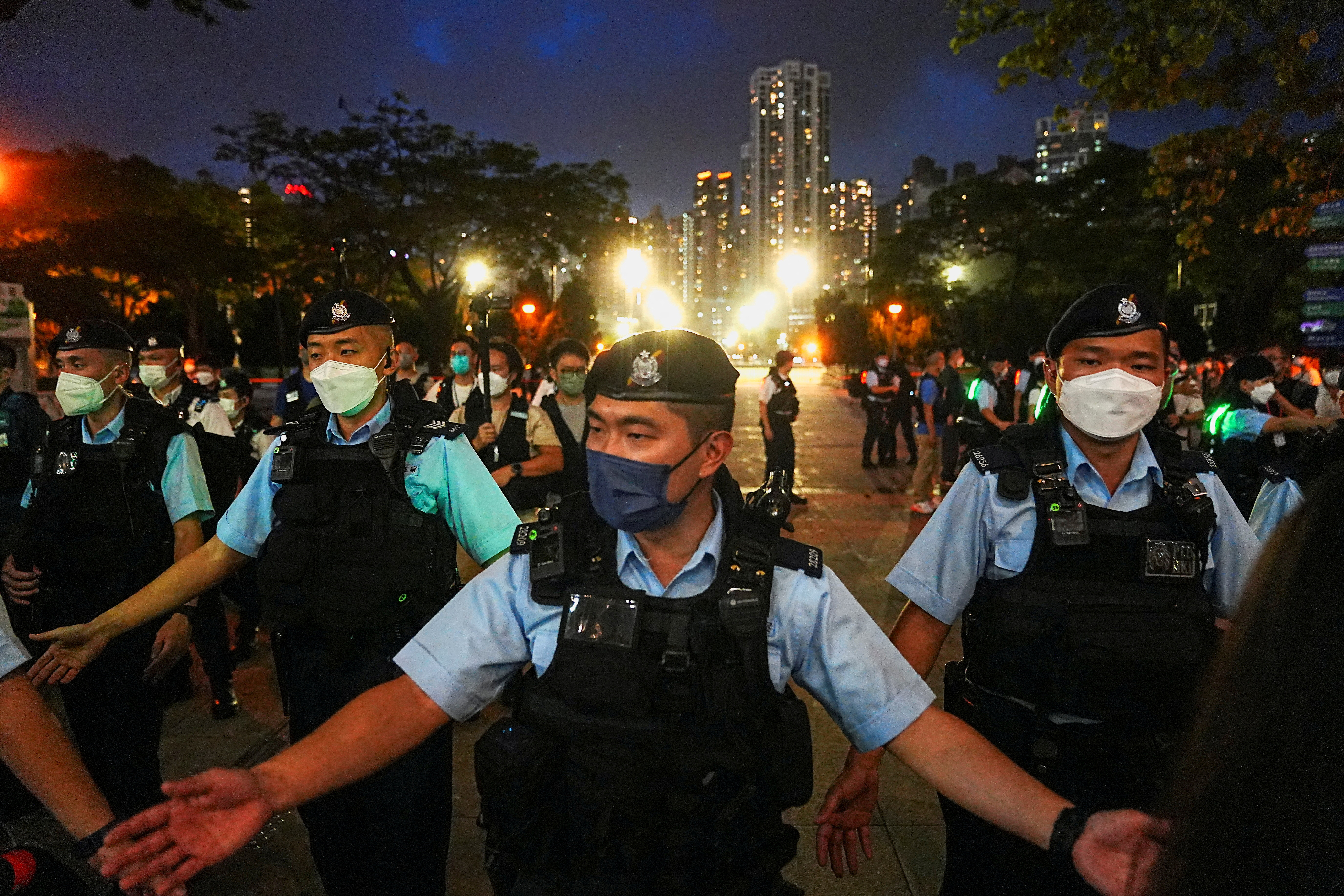 FILE PHOTO: Police officers disperse people at the closed Victoria Park on the 33rd anniversary of the crackdown on pro-democracy demonstrations at Beijing's Tiananmen Square in 1989, in Hong Kong, China, June 4, 2022. REUTERS/Lam Yik