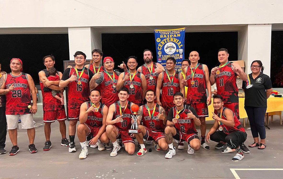 The New Chang Ming players pose with the open division championship trophy of the Saipan Centennial Lions Club Invitational Basketball League after defeating the Martech Ol'Aces, 82-77, on Tuesday at the Koblerville gym.