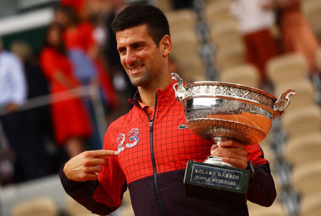 Serbia's Novak Djokovic poses with the trophy after winning the French Open and his 23rd Grand Slam as seen on his jacket at Roland Garros, Paris, France on June 11, 2023.