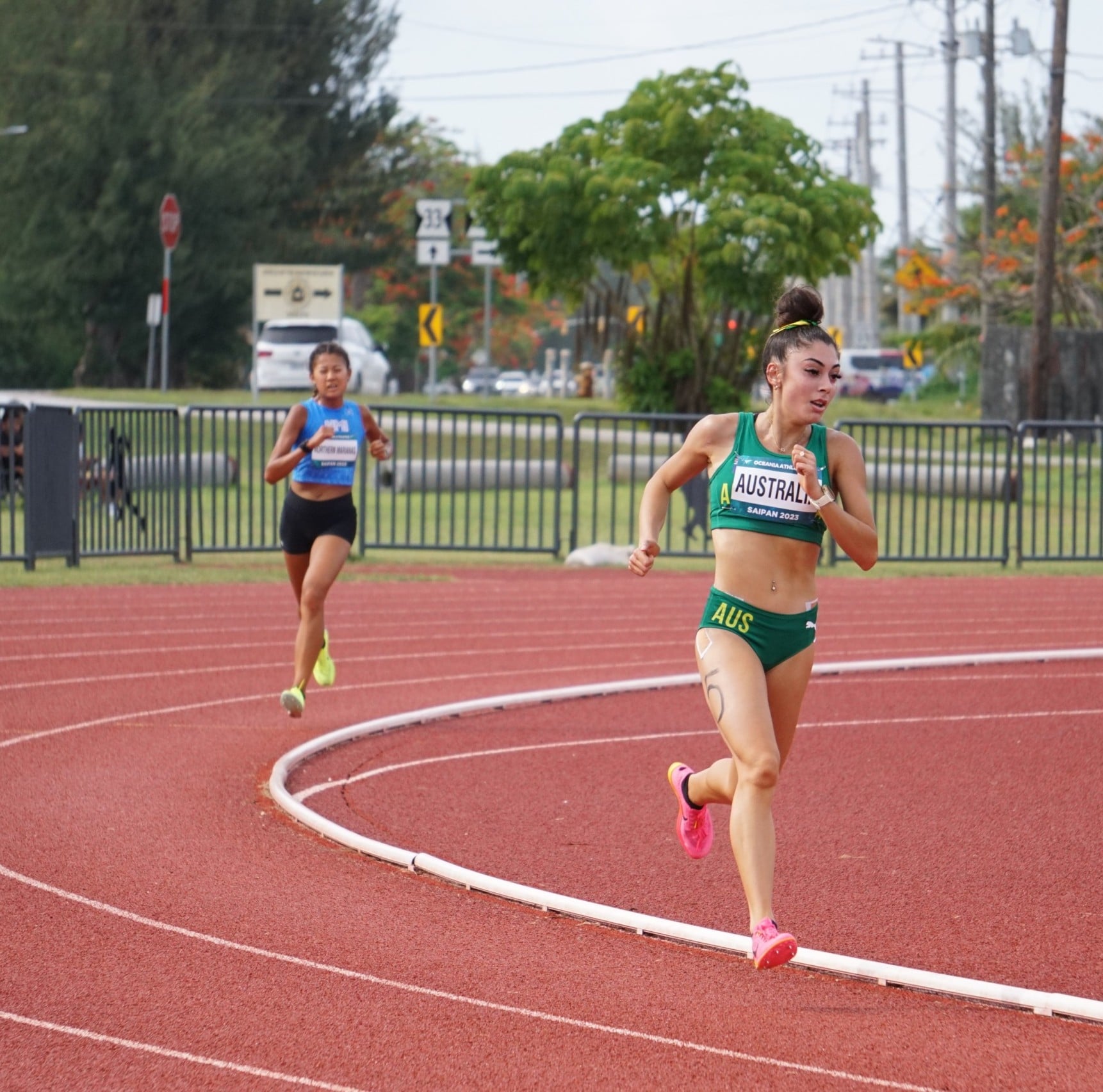 Australia's Layla Liakatos leads with the NMI's Tania Tan right behind during the women's 3000M event of the 2023 Oceania Cup Saturday at the Oleai Sports Complex Oval track and field.