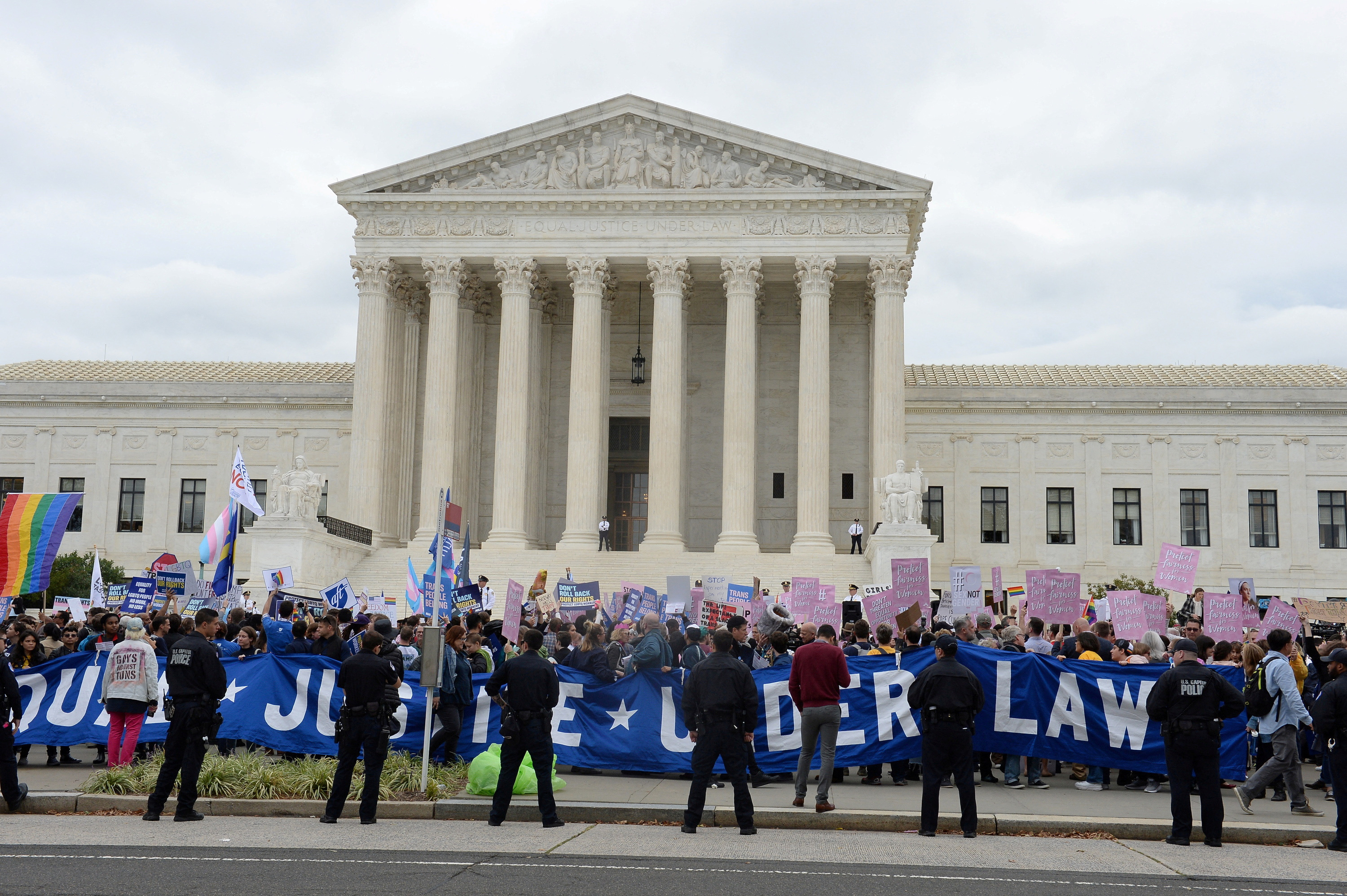 FILE PHOTO: United States Capitol Police lines up along the perimeter while LGBTQ activists and supporters hold a rally on the steps of the Supreme Court as it hears major LGBT rights case on whether federal employment law that outlaws discrimination on the basis of sex covers sexual orientation and gender identity, in Washington, U.S., October 8, 2019. REUTERS/Mary F. Calvert