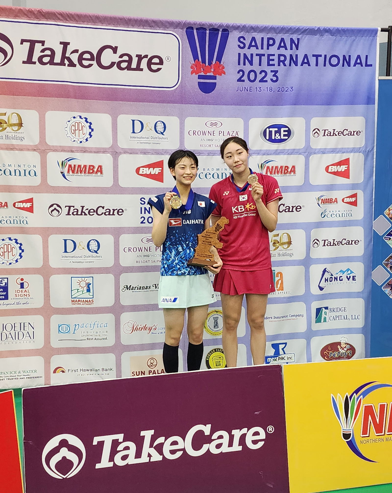 Japan’s Tomoka Miyazaki and South Korea’s Kim Ga Ram pose with their medals following their women's singles match in the TakeCare Saipan International 2023 Sunday at the Ada gym.