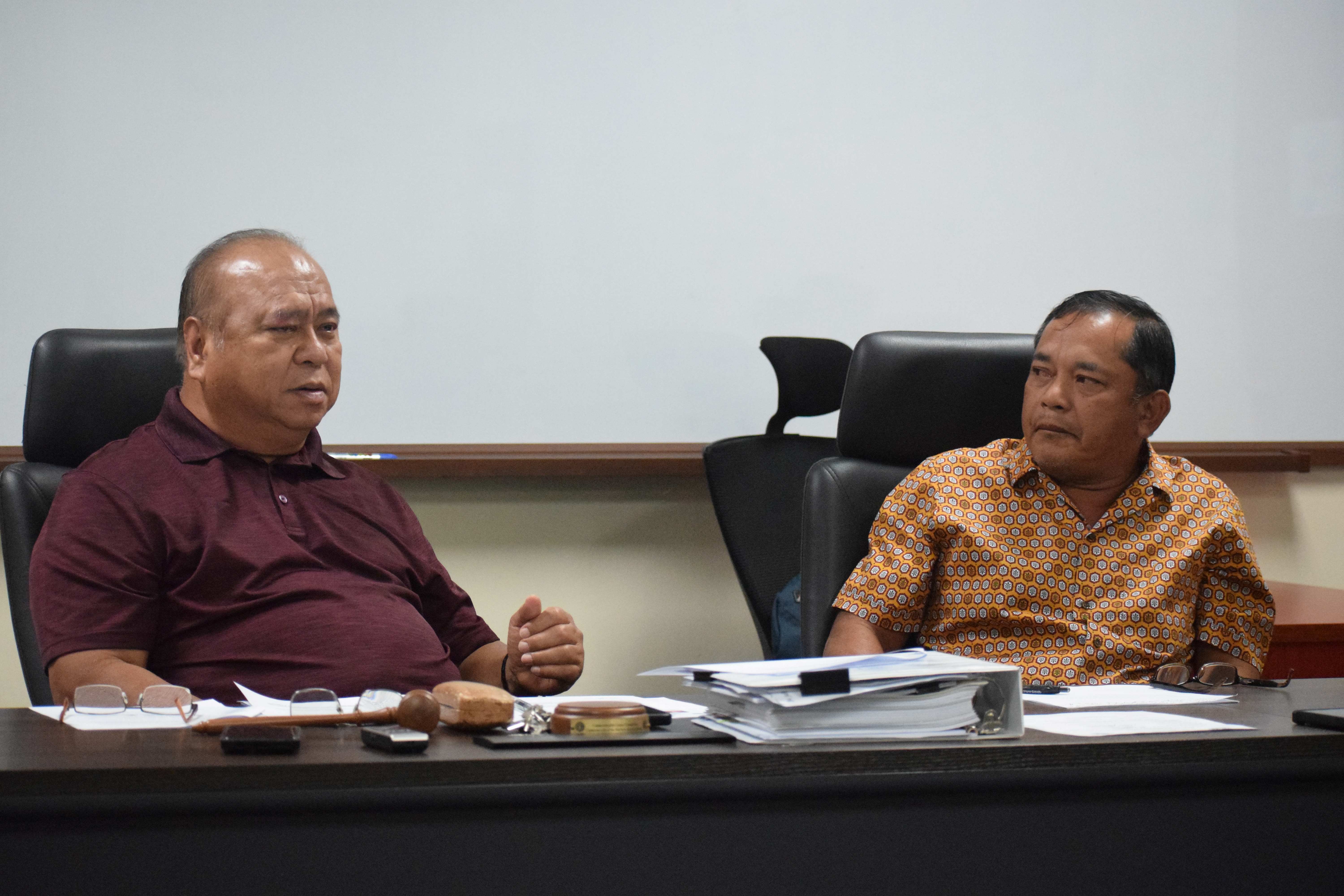 Commonwealth Casino Commission Chairman Edward C. Deleon Guerrero, left, speaks as Vice Chairman Ralph S. Demapan listens during a meeting on Wednesday in the CCC conference room at Springs Plaza in Gualo Rai.