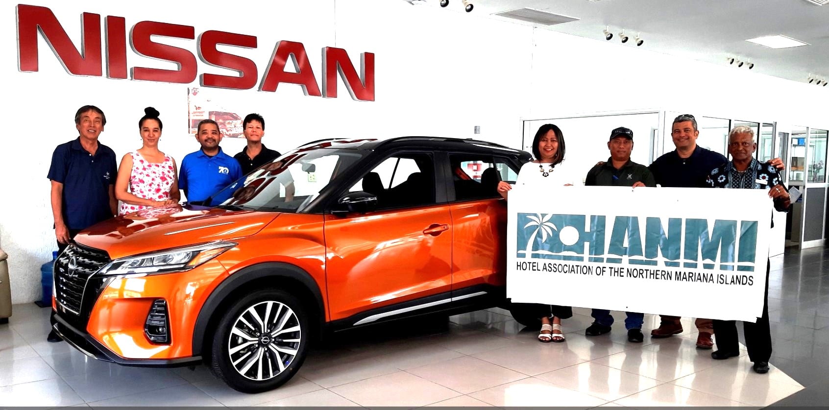 Joeten Motors Sales Manager Ray Alvarez, second right, presents a 2023 Nissan Kicks as a hole-in-one prize for the 21st Annual HANMI Charity Classic Golf Tournament, scheduled for July 15, 2023, at LaoLao Bay Golf & Resort west course. Also pictured are tournament committee chairman Juko Ishikawa, far left and other Joeten Motors management and staff and committee members.