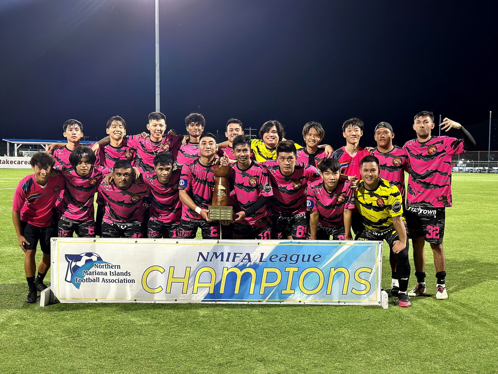 Eleven Tiger FC players pose with the championship trophy of the Marianas Soccer League 1 on Sunday, June 11, 2023 at the NMI Soccer Training Center in Koblerville.
