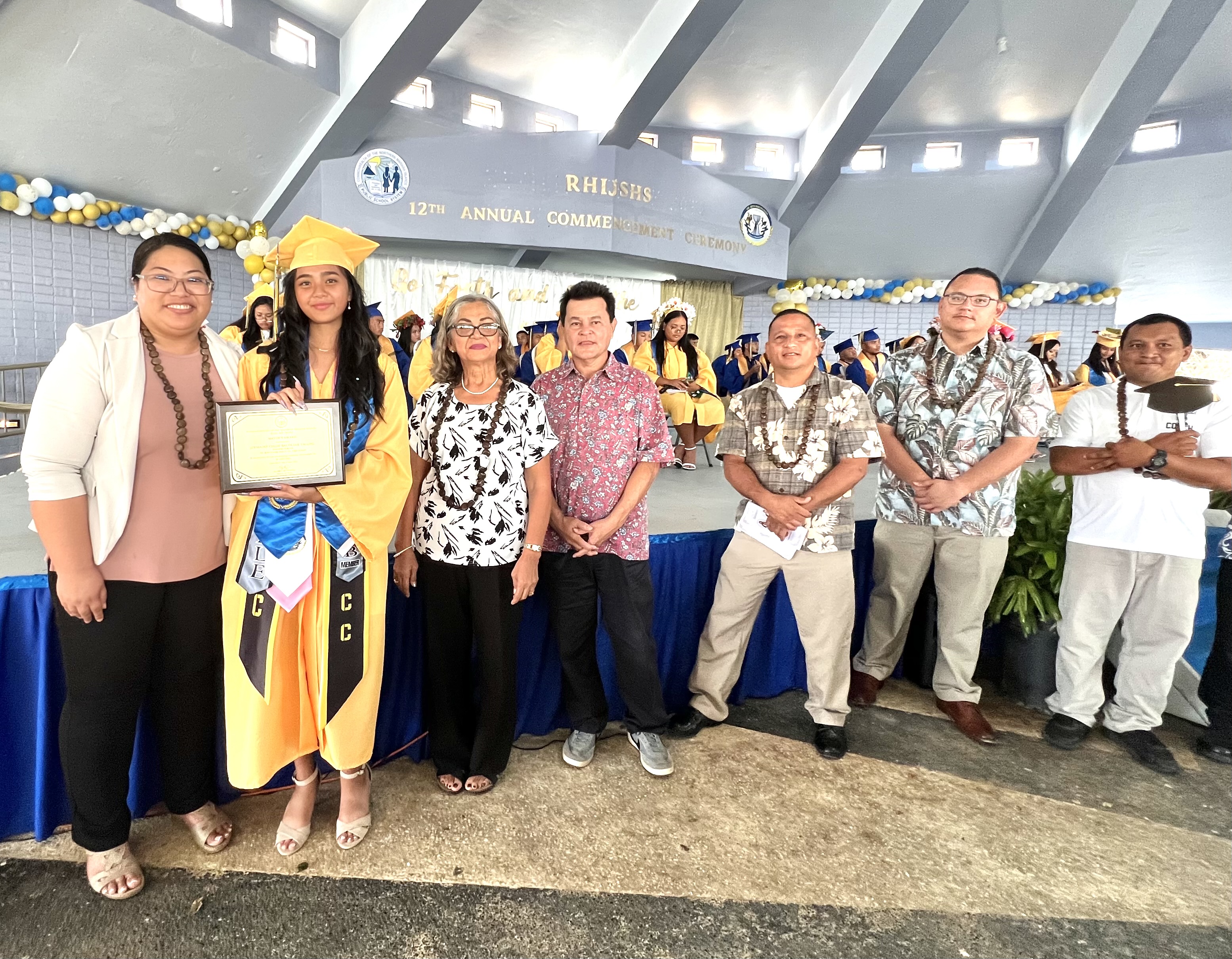 Rota Mayor Aubry Hocog with Senate Vice President Donald Manglona and other officials present the Mayor’s Award to class valedictorian Jermaine Chloe Baltazar Yalung.