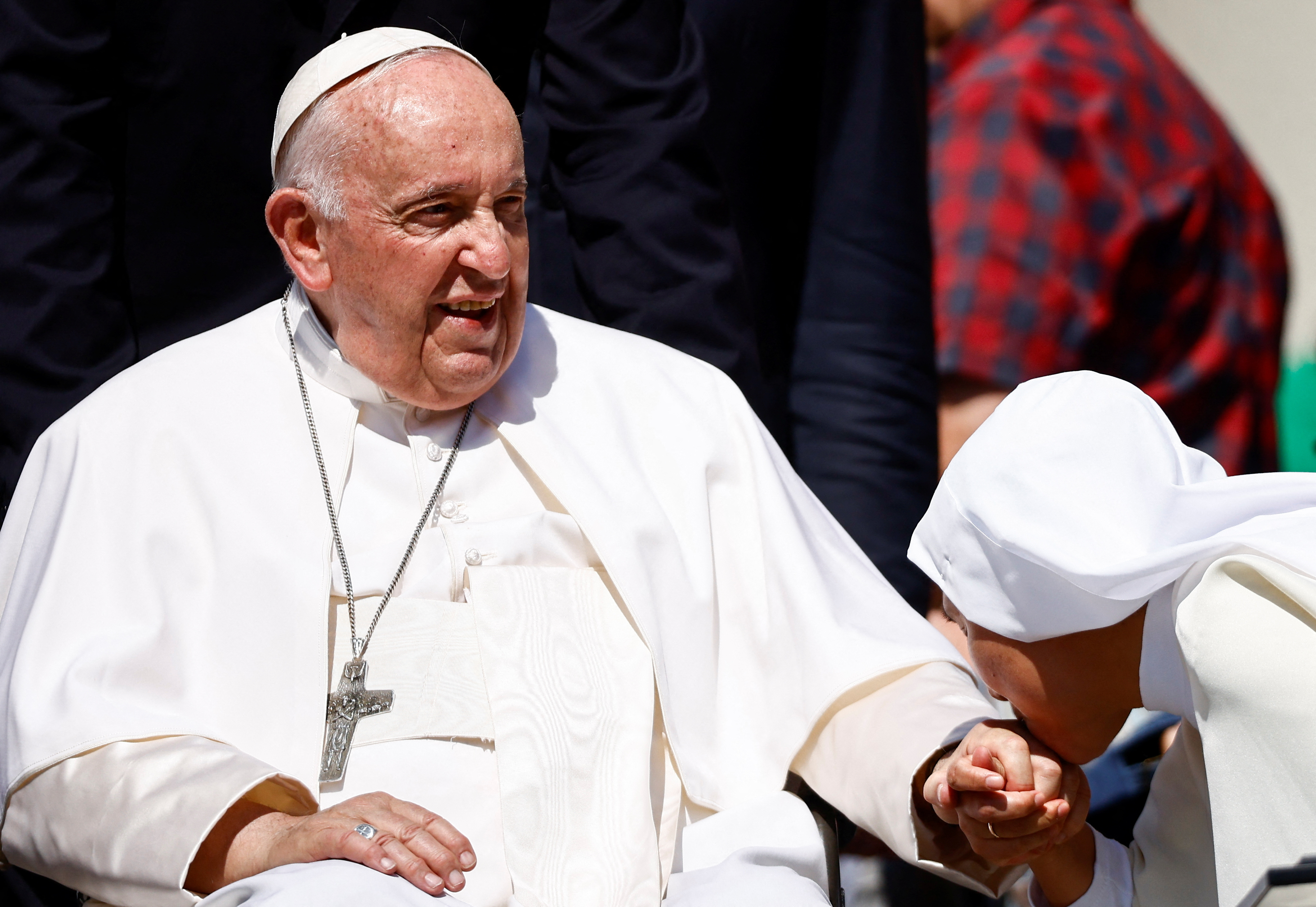 A nun kisses the hand of Pope Francis during the weekly general audience on the day he is due to undergo abdominal surgery, in St. Peter's Square at the Vatican, June 7, 2023. REUTERS/Yara Nardi