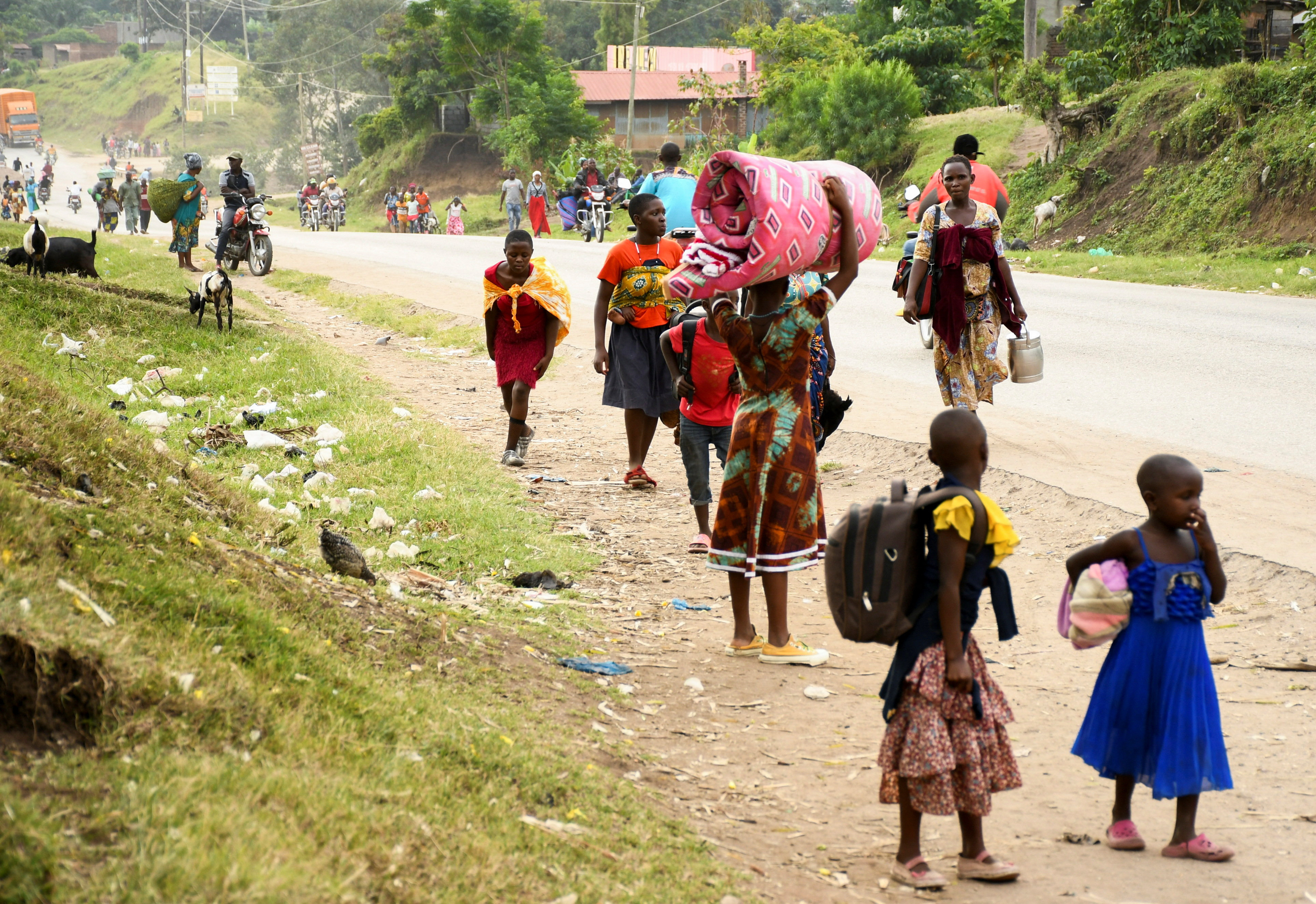 Residents flee from Bwera after militants linked to rebel group Allied Democratic Forces (ADF) killed and abducted multiple people at the Mpondwe Lhubirira Secondary School, in Mpondwe, western Uganda, June 17, 2023. REUTERS/Stringer