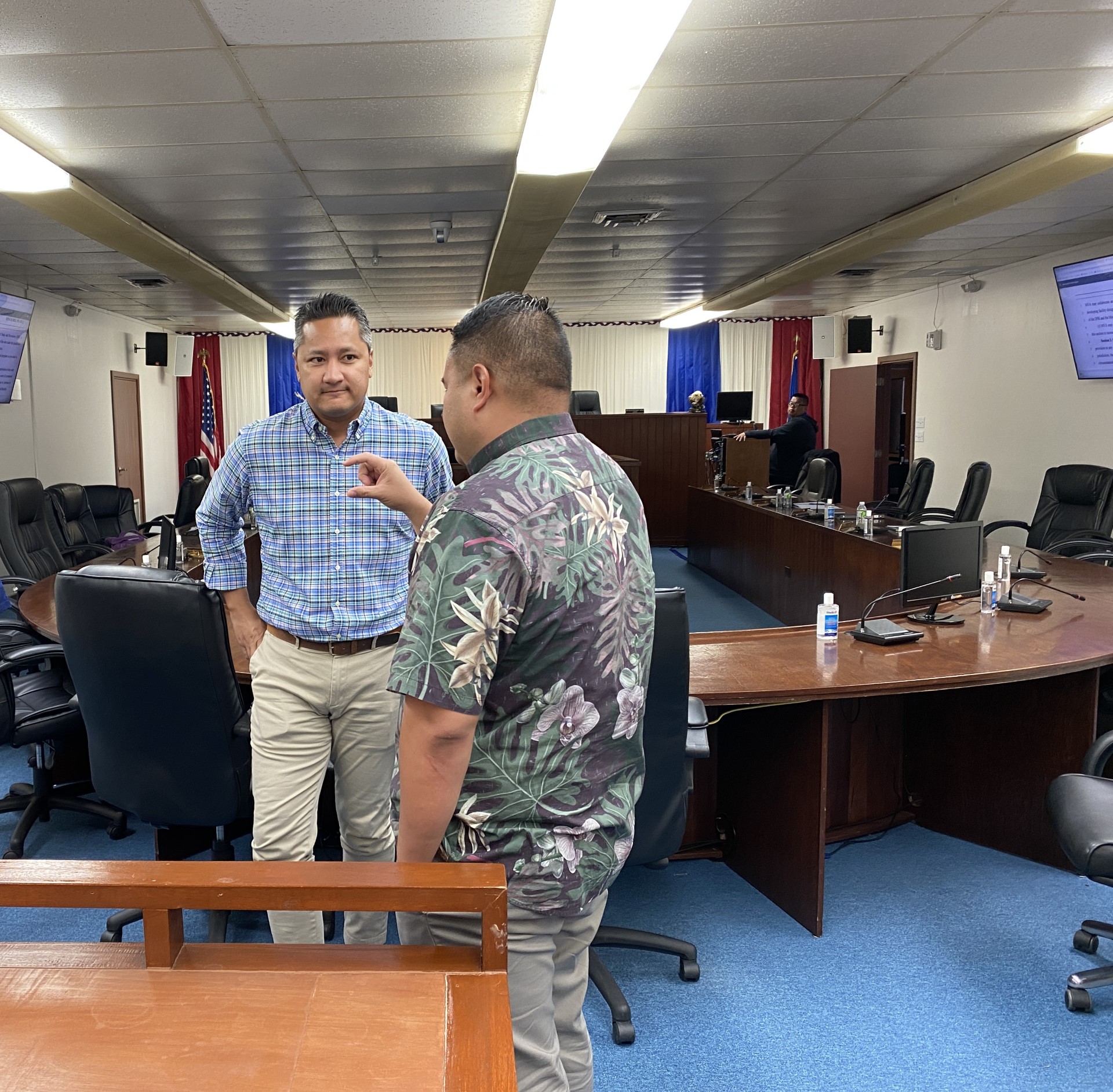Marianas Visitors Authority Managing Director Chris Concepcion, left, listens to Rep. Manny Castro following a hearing conducted by the House Committee on Commerce and Tourism on Monday.