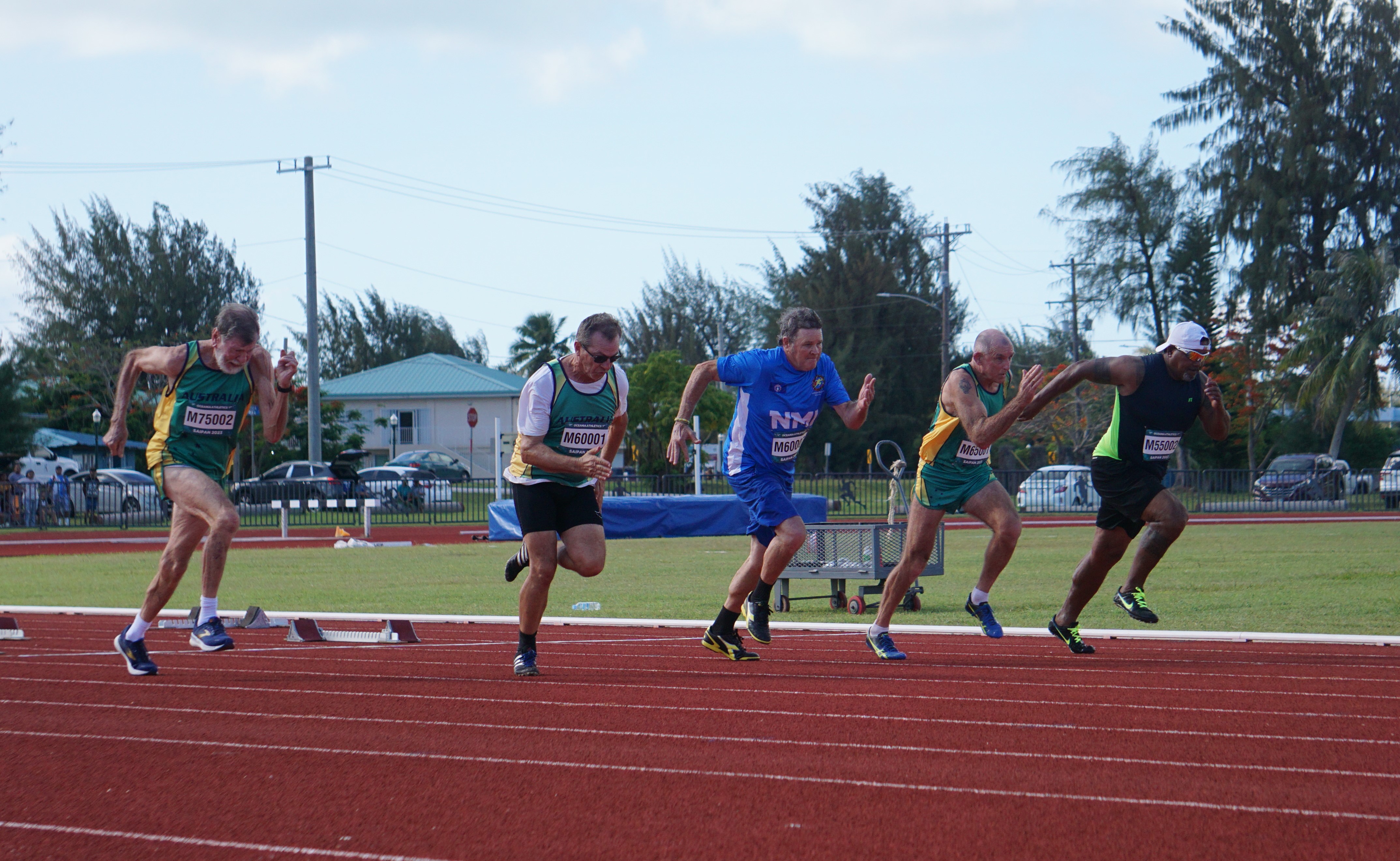The NMI's Tony Ichiuo, right, and other runners take off in the 60-meter event of the 2023 Oceania Masters Championships at the Oleai Sports Complex track and field oval.